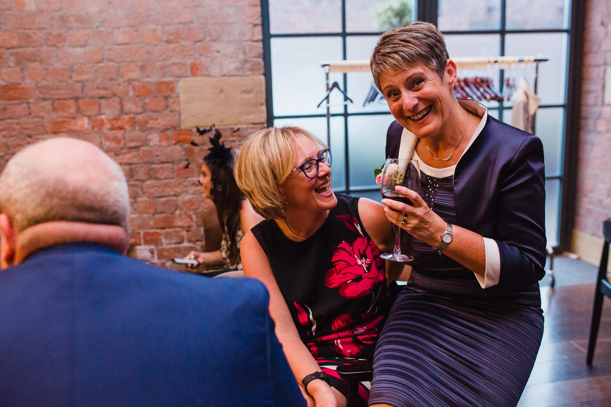Jess and Ben - Liverpool wedding - guests laughing