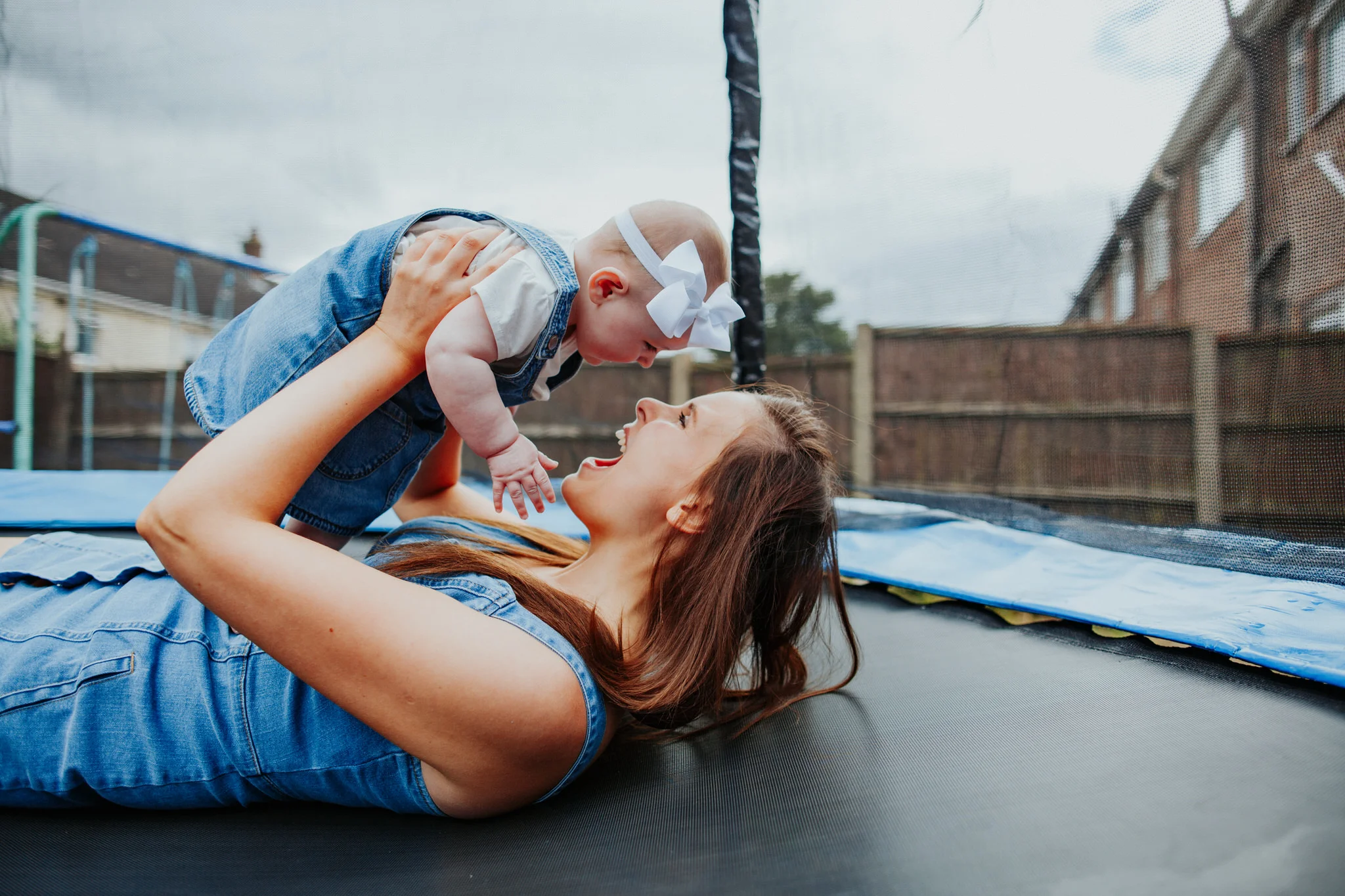 Mum and daughter jumping on trampoline