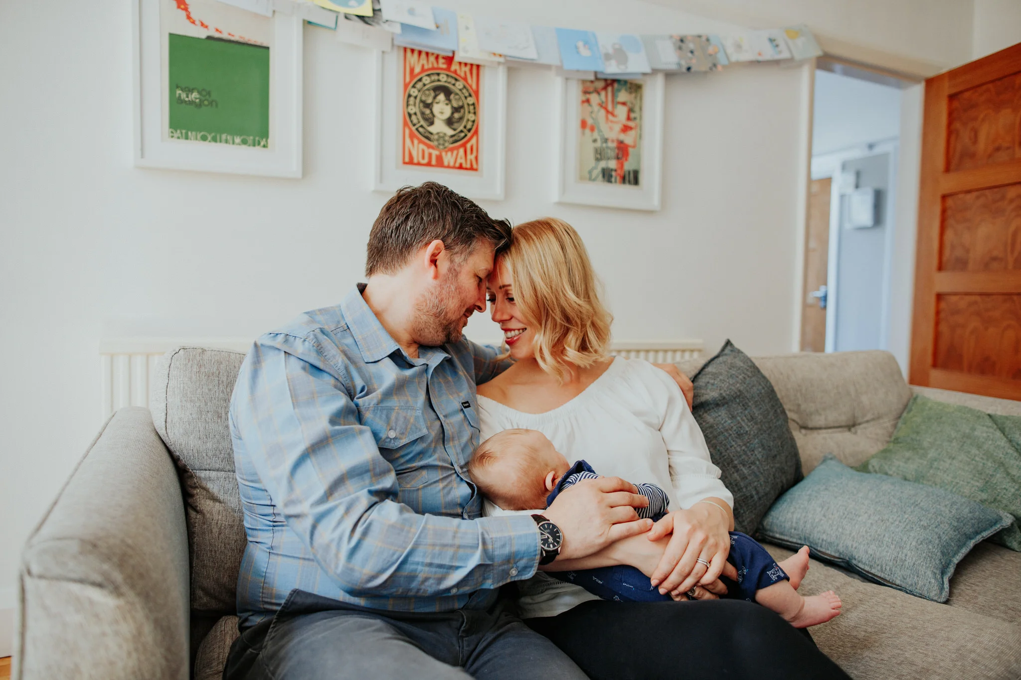 mum and dad holding new born baby