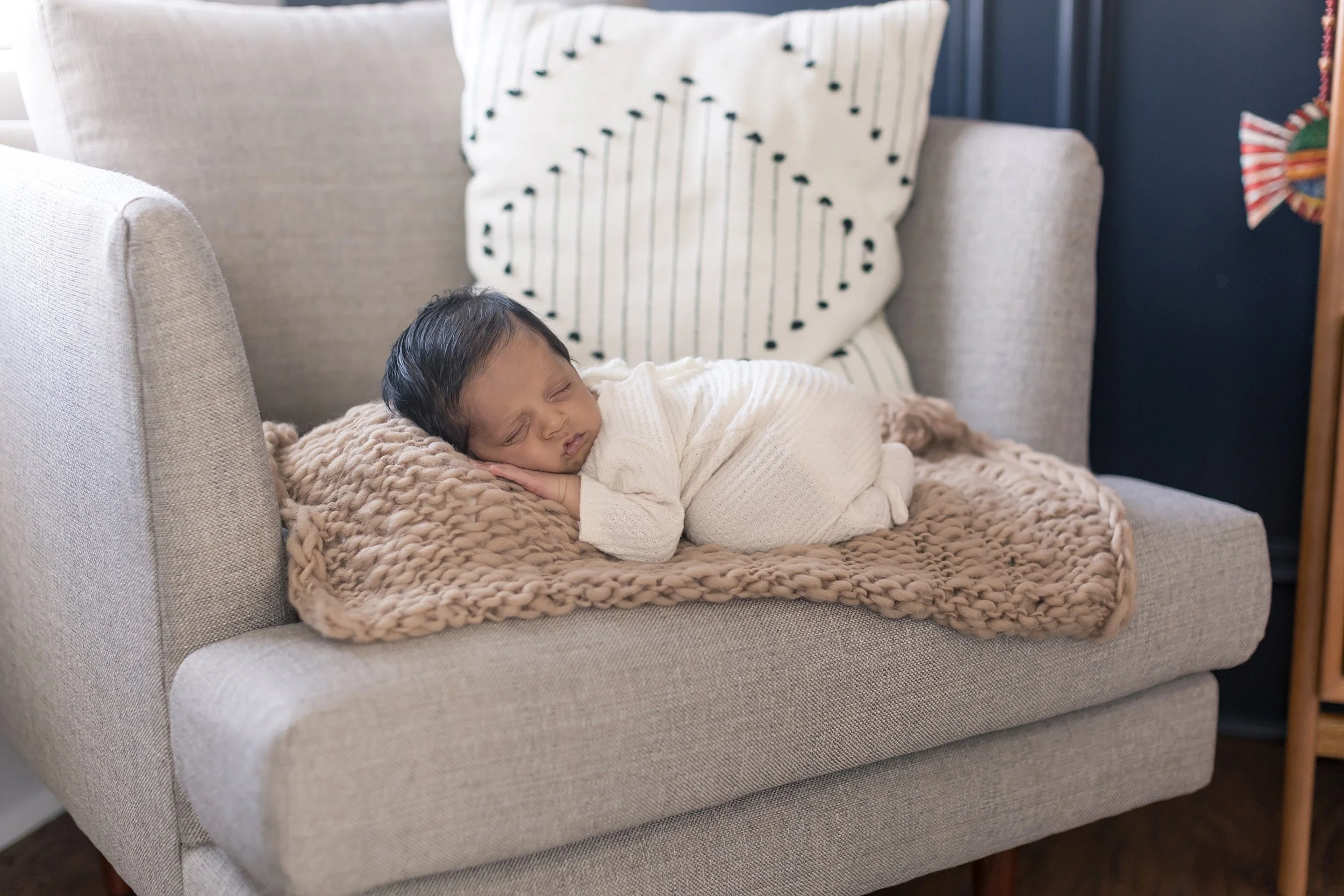 baby boy laying on the couch at his inhome newborn photography session in Evans, ga