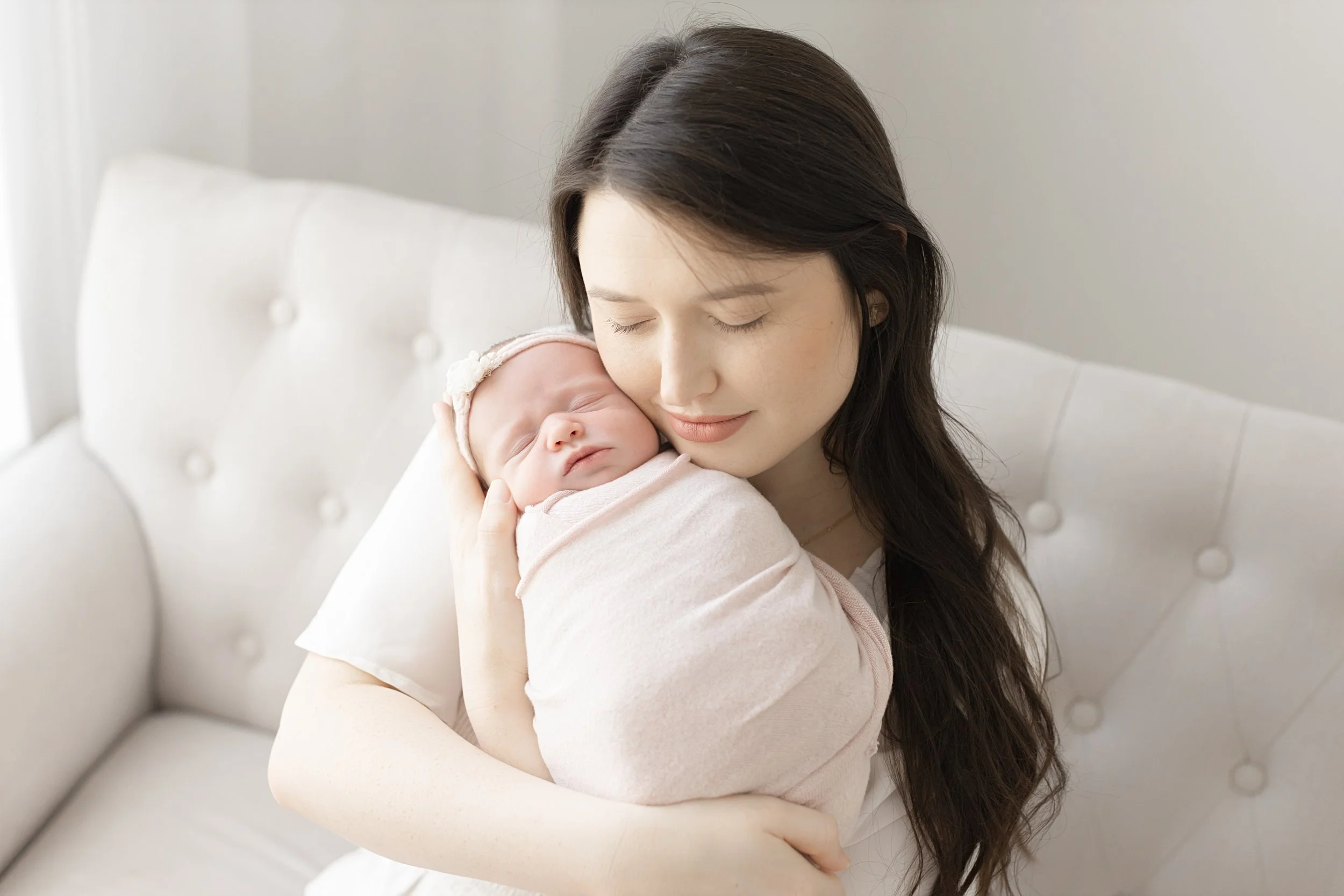 mom holding newborn baby girl at her newborn photography session in Evans ga