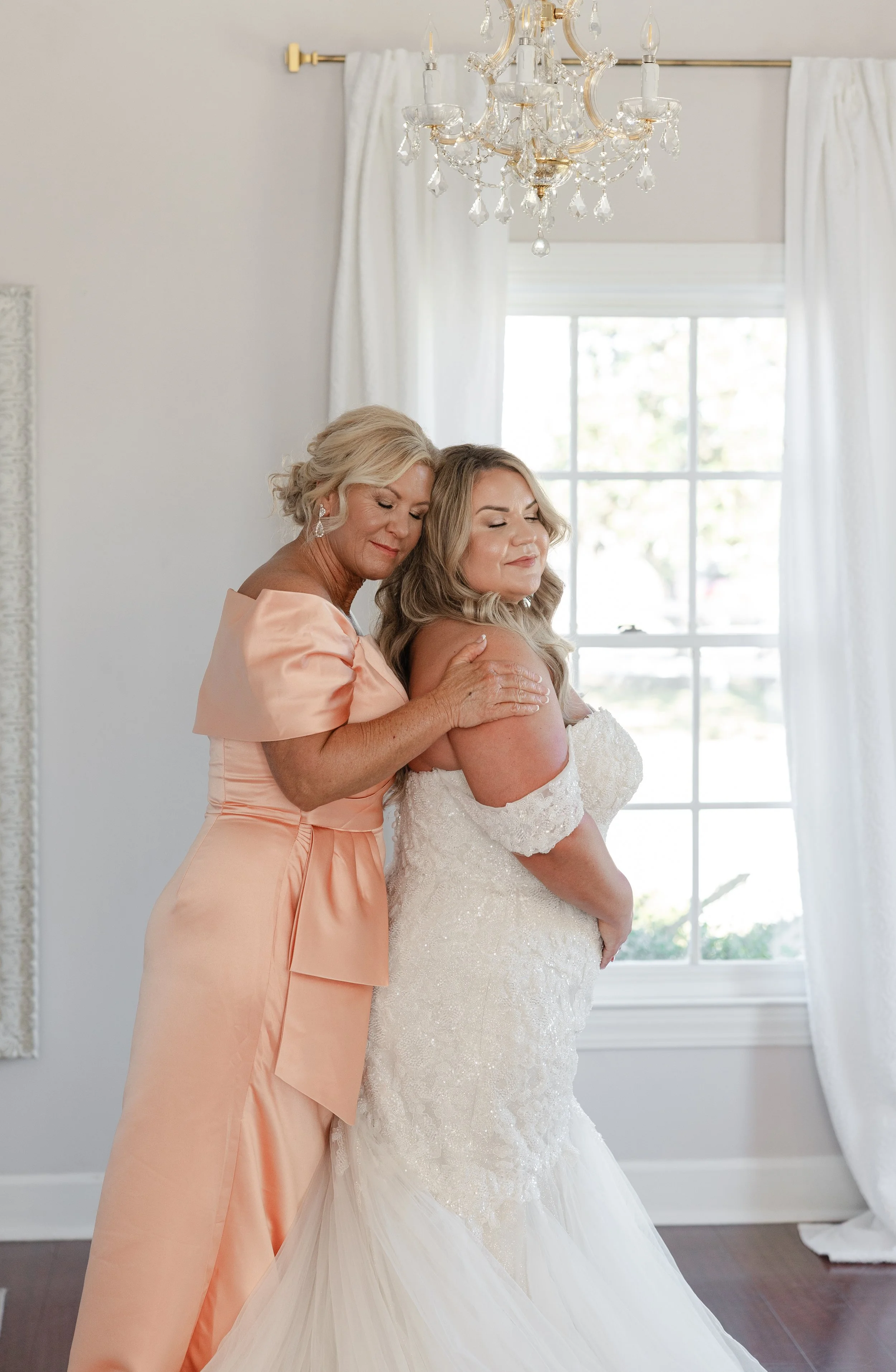 mom hugging her daughter during her wedding day at grace wood manor in Augusta GA