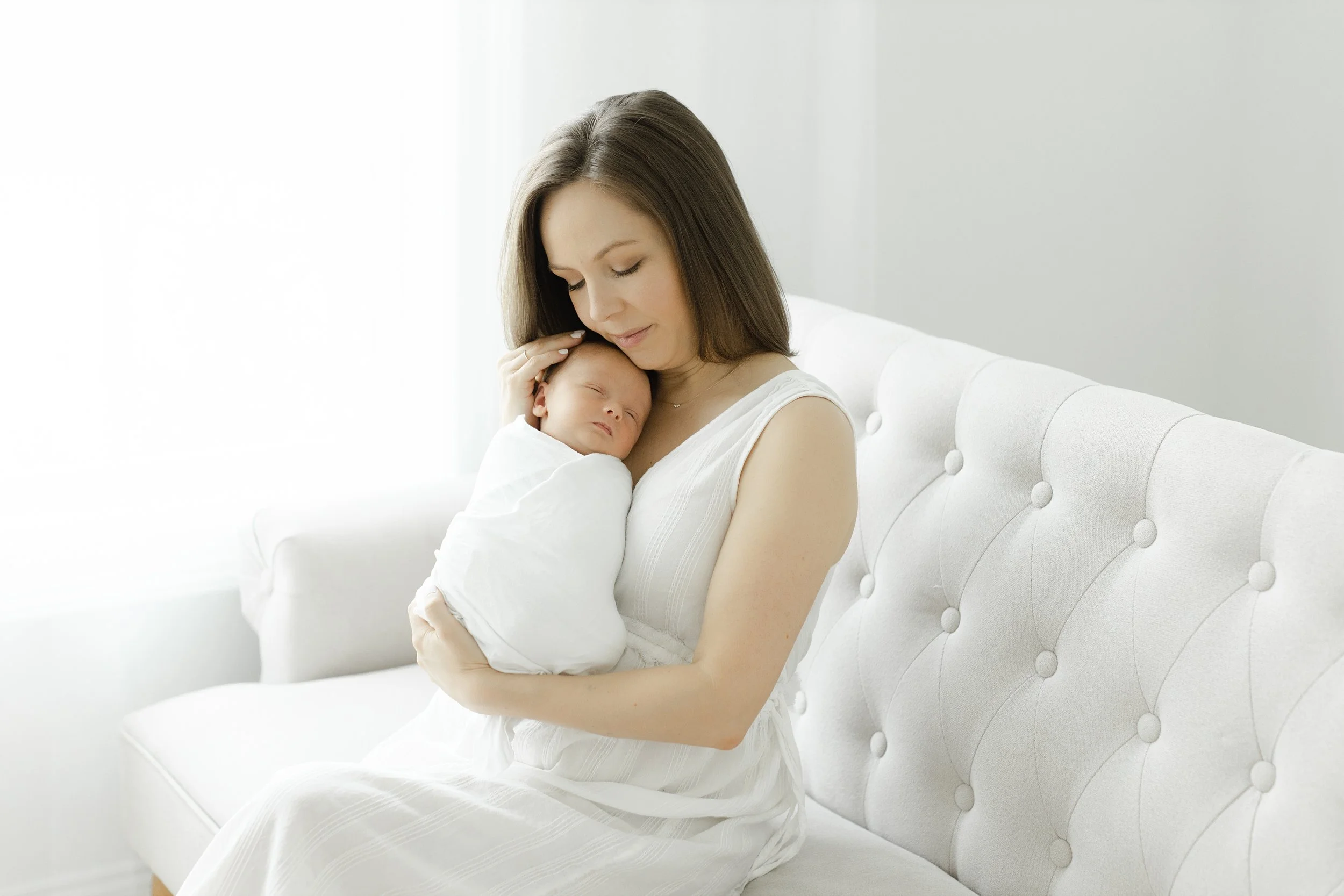 mom snuggling newborn baby boy at their baby photography session in Augusta ga