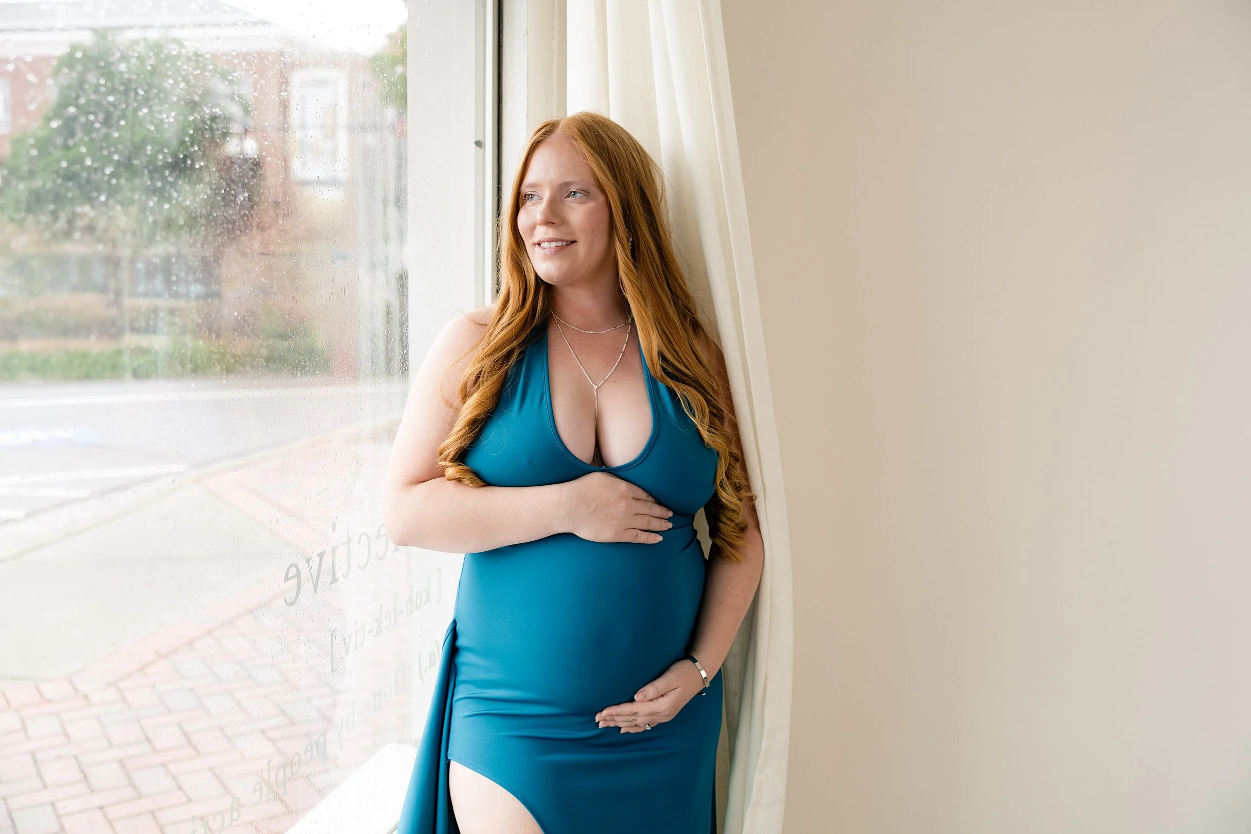 Expecting mother in a white lace maternity outfit during a studio maternity session at The Collective in North Augusta SC