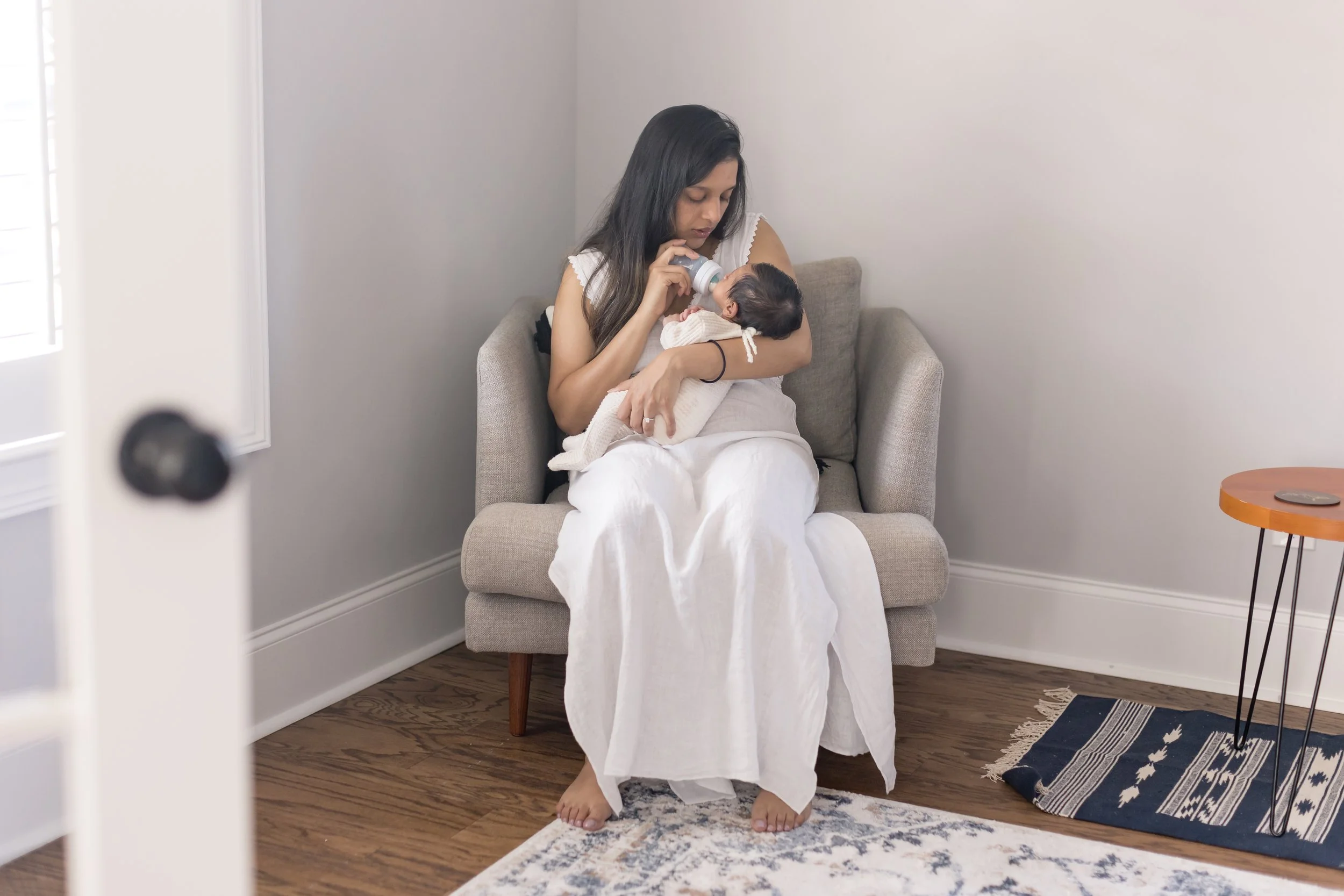 mom feeding newborn baby boy at their inhome newborn photography session in Evans ga