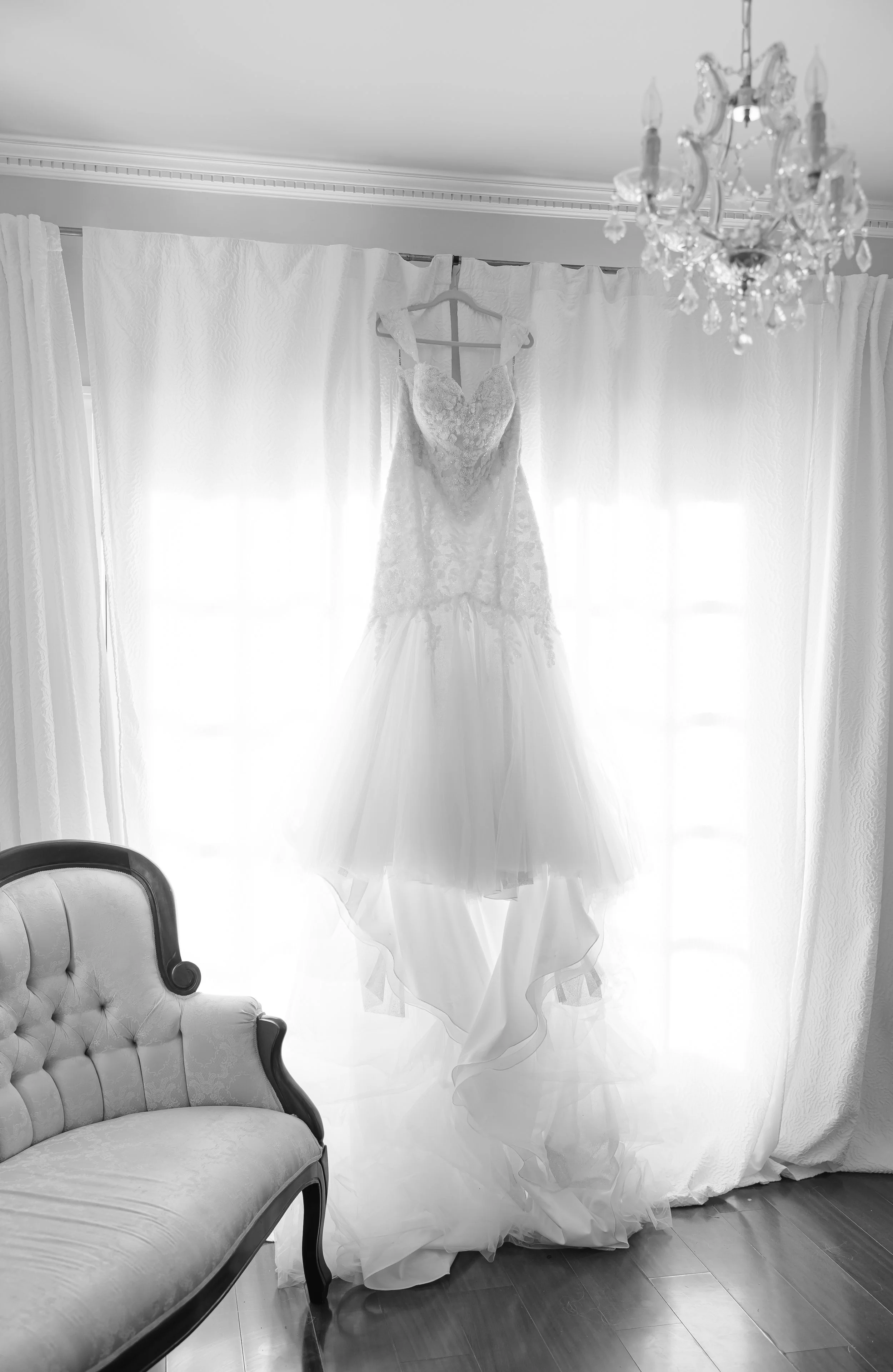 wedding dress hanging in the window at grace wood manor in Augusta GA