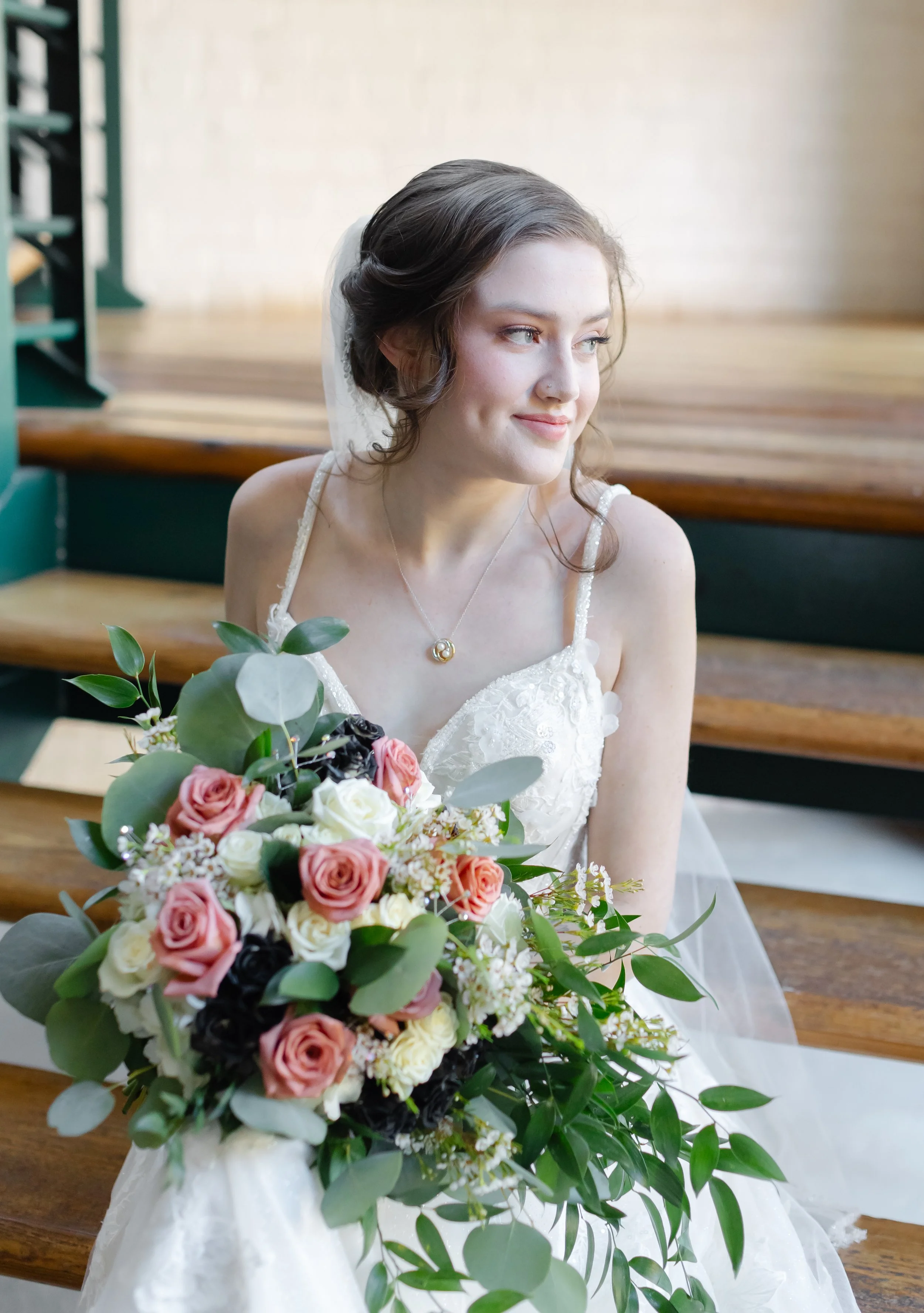 bride sitting on stairwell at enterprise mills in Augusta Georgia for her bridal portraits