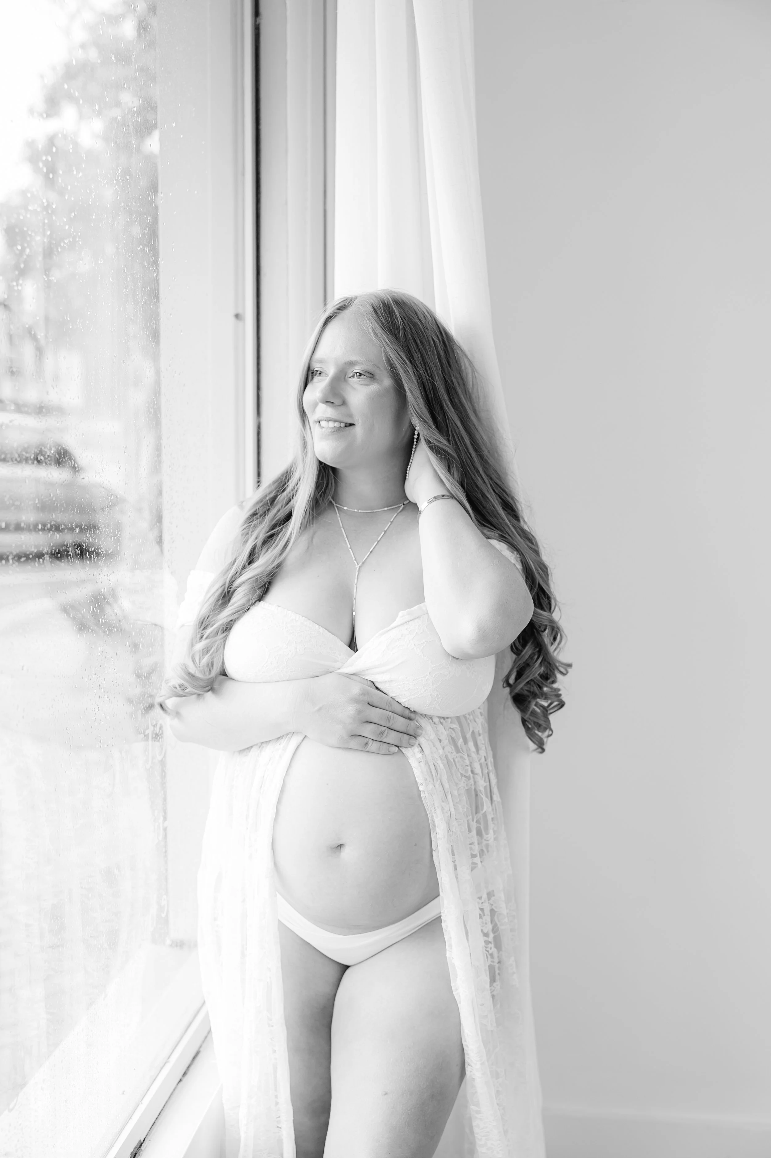 Expecting mother in a white lace maternity outfit during a studio maternity session at The Collective in North Augusta SC