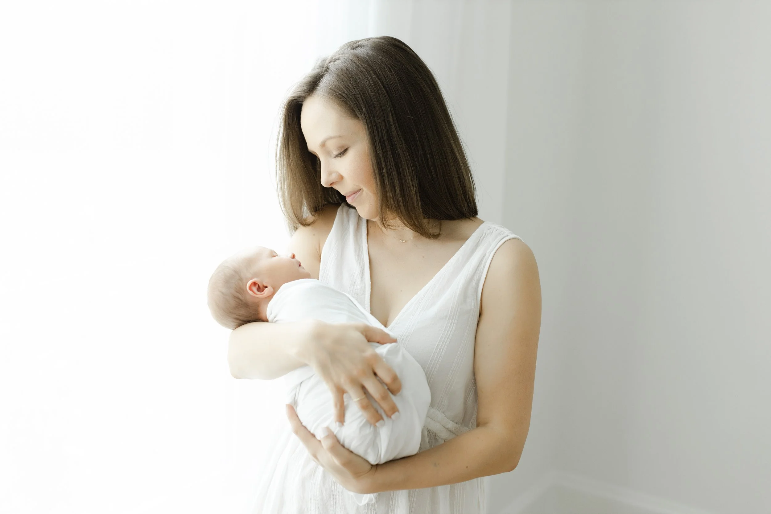 mom holding newborn baby boy at her newborn photography session in Augusta ga