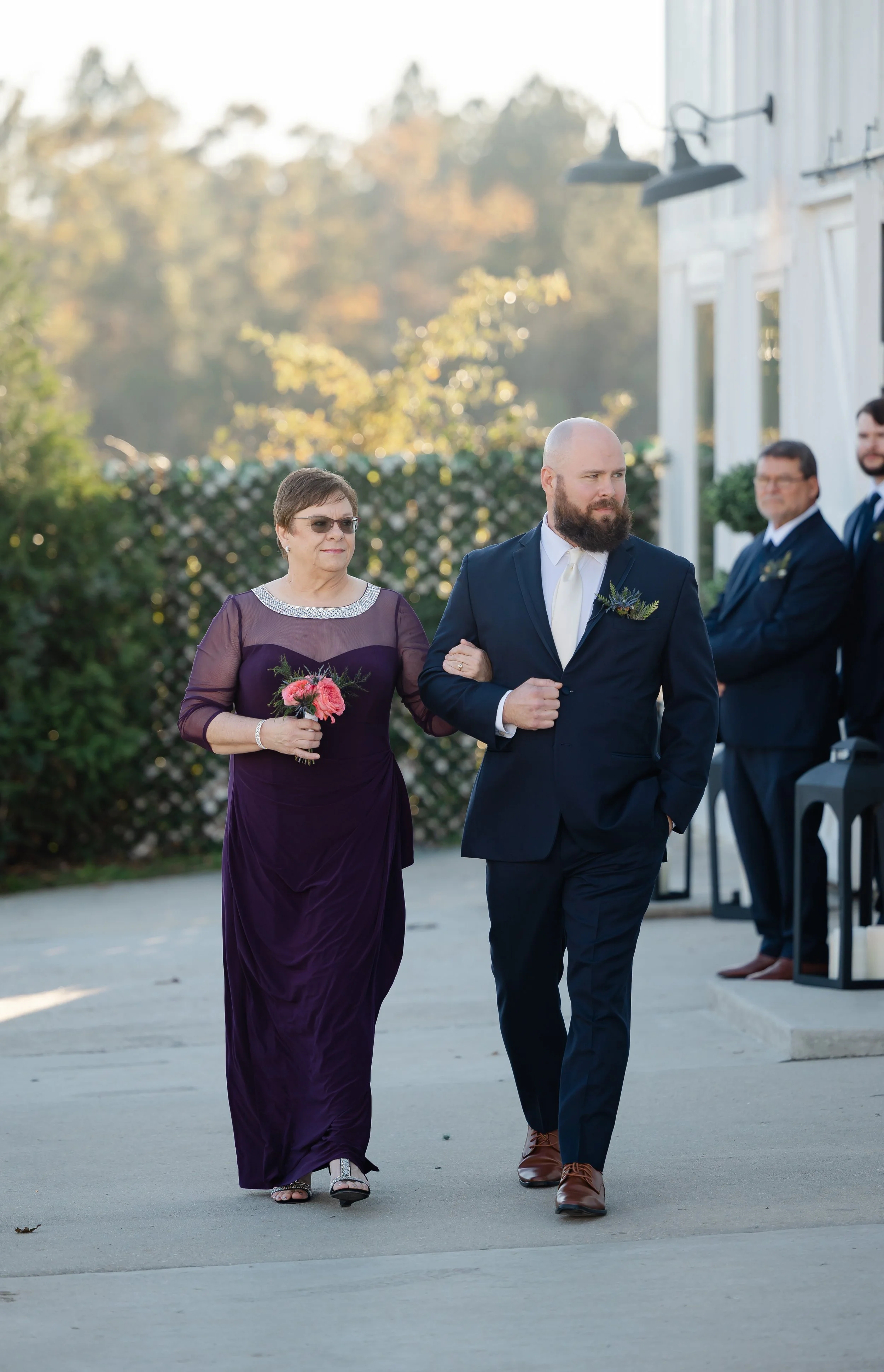 groom walking down the isle with his mom at grace wood manor at his wedding day