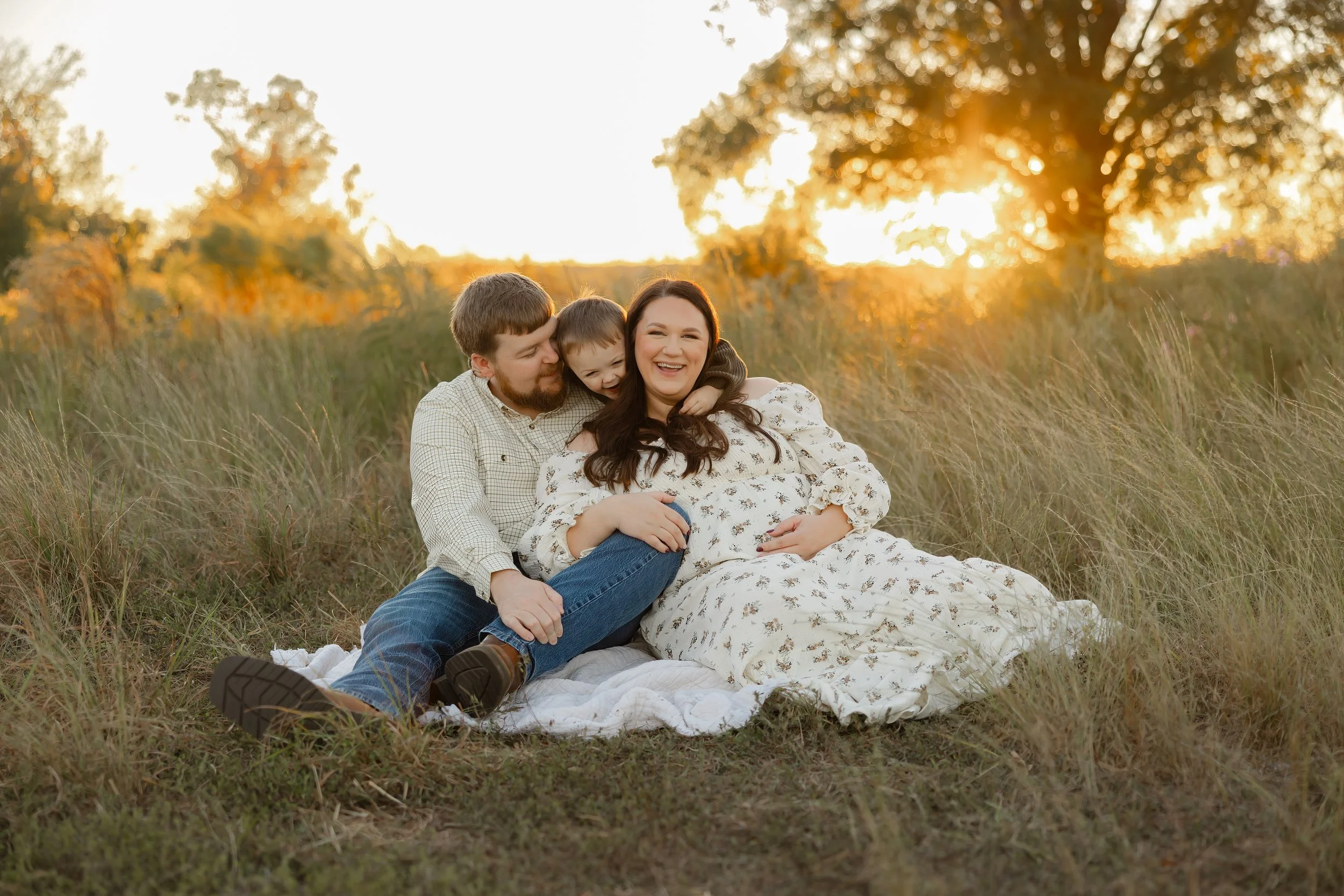 Family maternity photos at Clarks Hill Lake with parents and their young son before welcoming a new baby