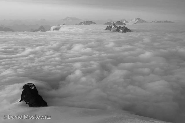 Looking south from the summit across a sea of clouds with only the highest peaks of the North Cascades jutting up like islands.
