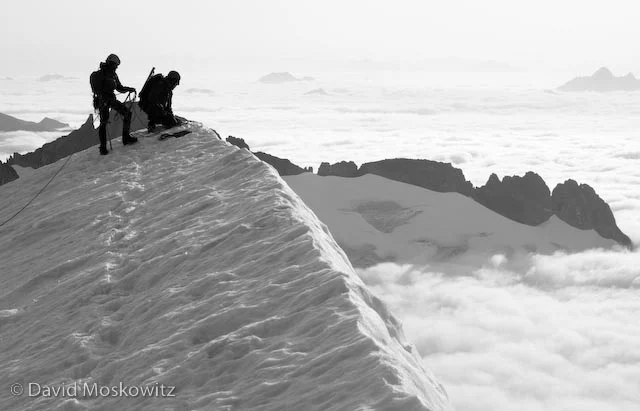 Inspecting the descent off of the snow arete on the south ridge of Eldorado.