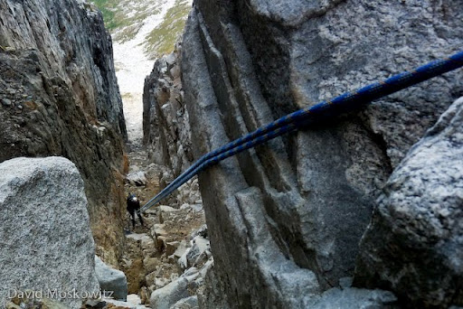 One last major obstacle descending south off of our last col, a steep gully (an eroded volcanic dike of which there were a number in the range which presented difficulties along the traverse) filled with large quantities of loose rocks. The light at the end of the chasm couldn’t come soon enough.