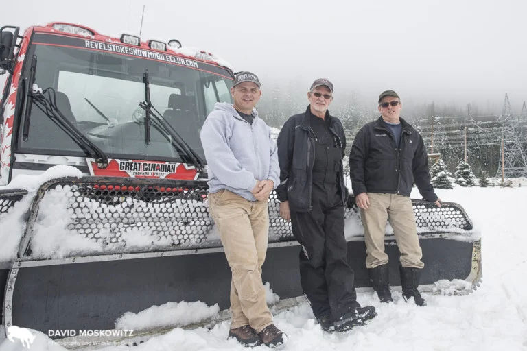 Daniel Kellie (left), owner of Great Canadian Snowmobile Tours and president of the Revelstoke Snowmobile Club , and club members Ron LaRoy (center), and Brad McStay lean on the front of one of the clubs groomers used to maintain the network of snowmobile trails the club manages all winter. Daniel noted that interest in snowmobiling in the Revelstoke area is growing, adding pressure to the areas currently easily accessible and legally open to to snowmobiling, a number of which have known mountain caribou populations.