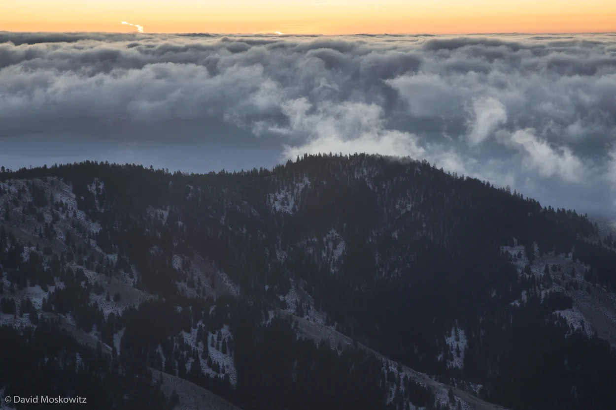 Low clouds sit over the valley at the first light of the day.
