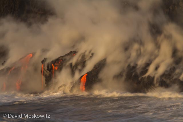 Lava from the Kilauea Volcano on the big isalnd of Hawaii pours over cliffs into the Pacific Ocean.