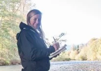 Naturalist Nicole Larson records her answers to track and sign questions along the Dosewallips River. Olympic Peninsula, Washington. Nicole earned a Level 2 Track and Sign Certificate.