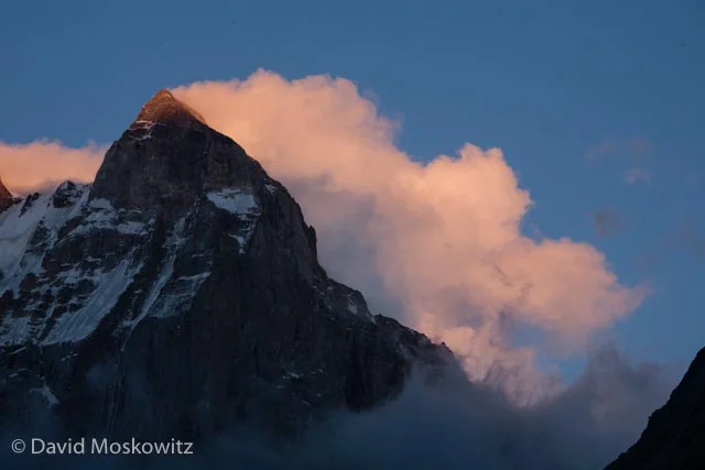 Though not the highest peak in the range, at 4,710 m (15,453 ft), Mount Ushba is a massive peak and generally considered the most challenging mountaineering objective in the range. Seen hear at sunset with a steady stream of clouds forming and streaming off of the lee side of the summit.