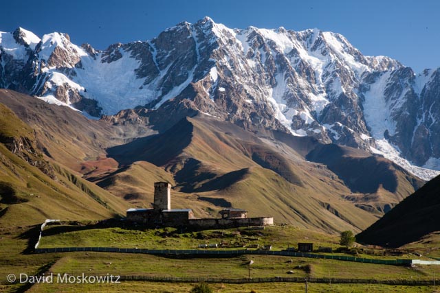 The Lamaria Church, near the town of Ushguli, with the southern face of Mount Shkhara, 5,193 m (17,040 ft), in the background.