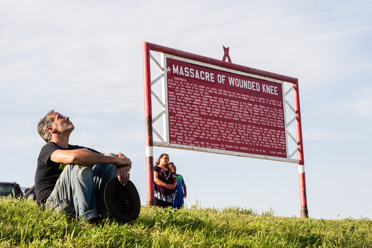 Will Scott and two other members of the gathering reflect at the site of the Wounded Knee Massacre. In 1890, the US military killed 146 Lakota men, women, and children who were camped here, the last armed conflict between the US military and the Lakota.