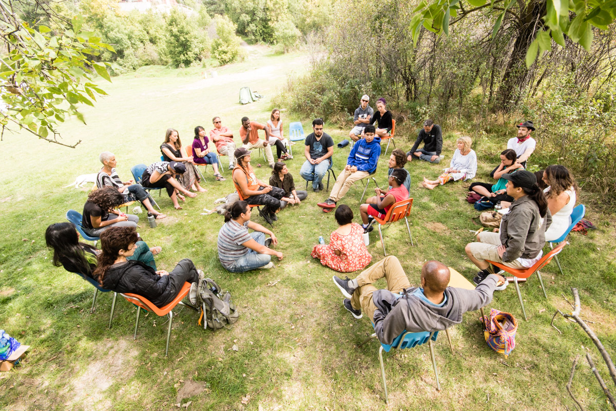  Much of the gathering was spent in talking circles, exploring issues of community, healing, and the work of youth initiation. In this group, younger members of the gathering were invited to sit in the center and share their experiences and challenge