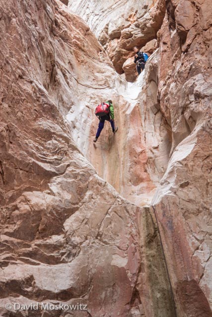  Ryan descending a steep step into a plung pool (hidden by the lip in front of it) while Lesley McClurg looks on. 