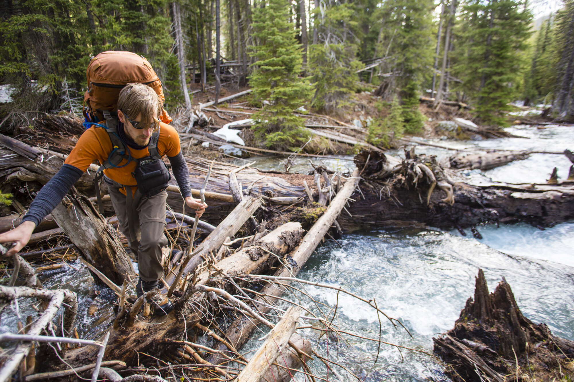  Jay Simpson crossing the upper Imnaha river on a log jam in the Eagle Cap Wilderness, Oregon. 