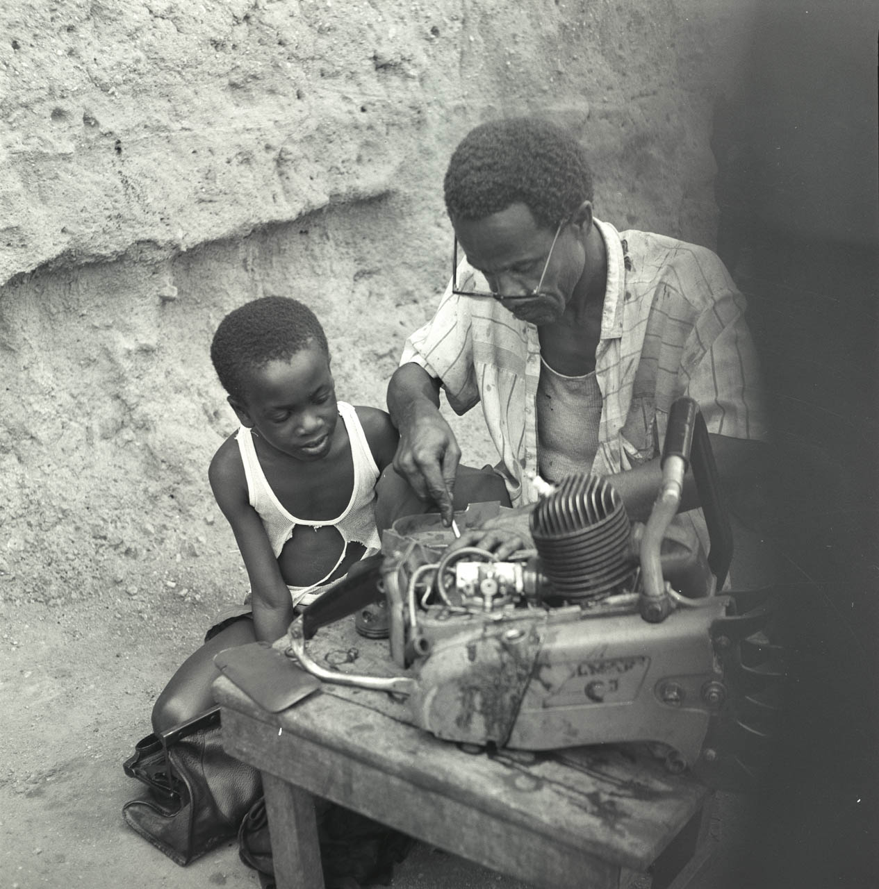 man working boy looks on.jpg