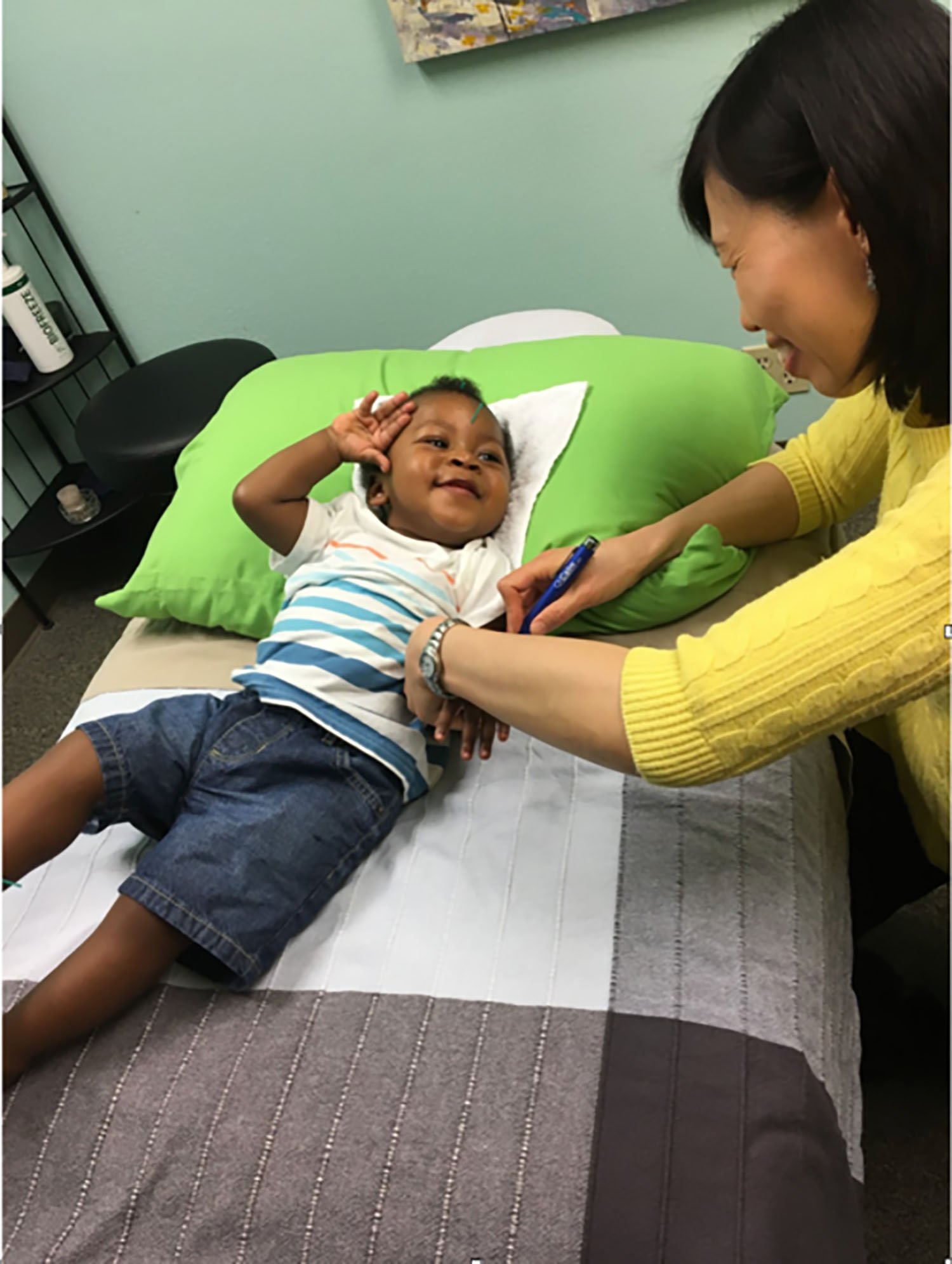 Dr. Iong Performing Acupuncture on a Baby