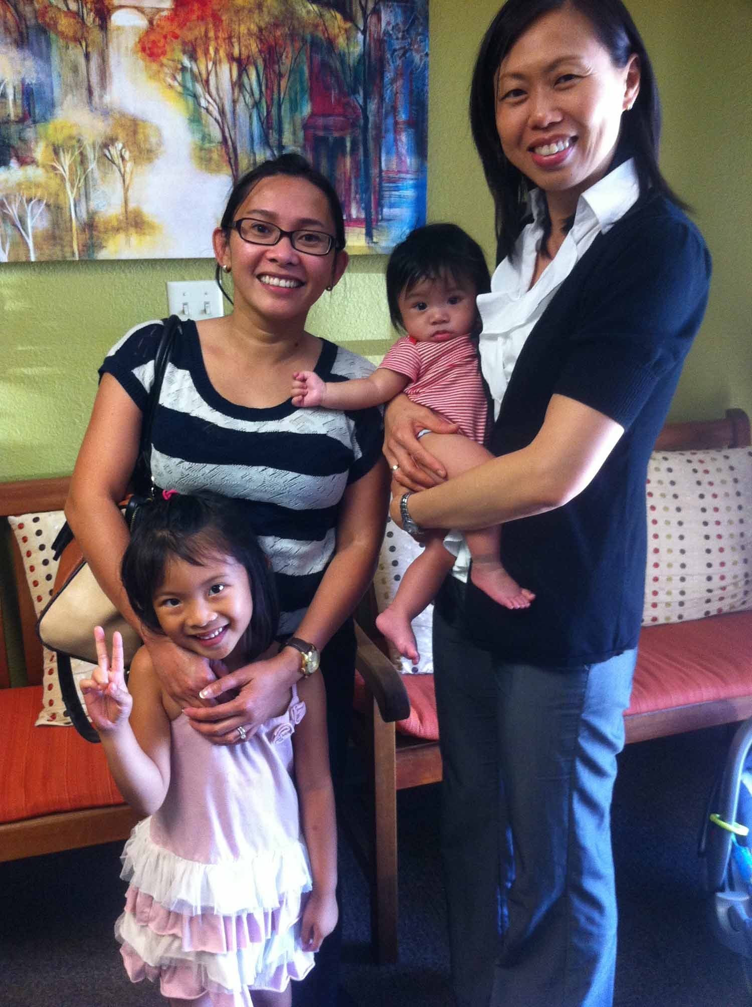 Dr. Iong with a Smiling Mother and Her 2 Children