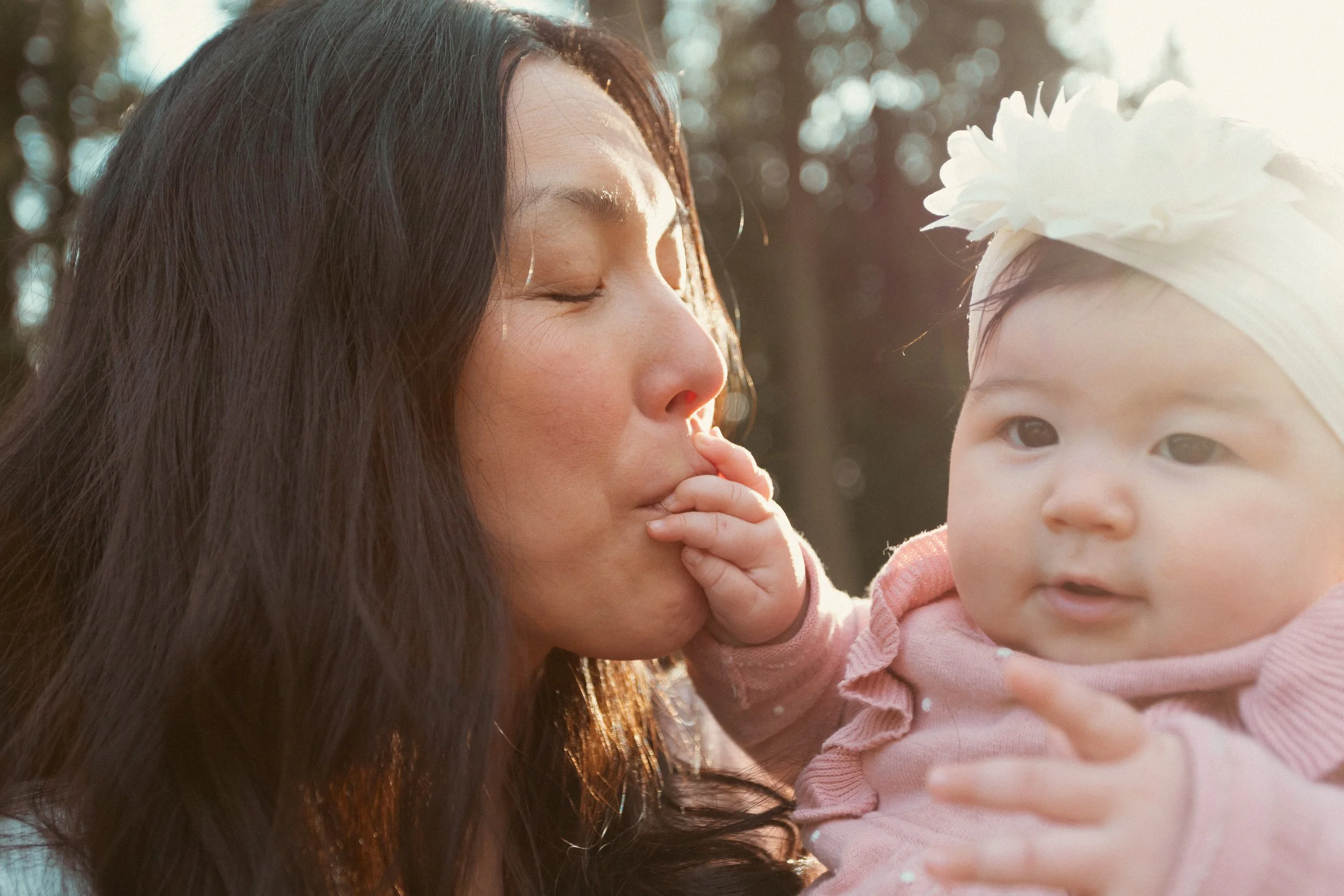 Mom kissing baby's hand, captured by Vancouver Family Photographer