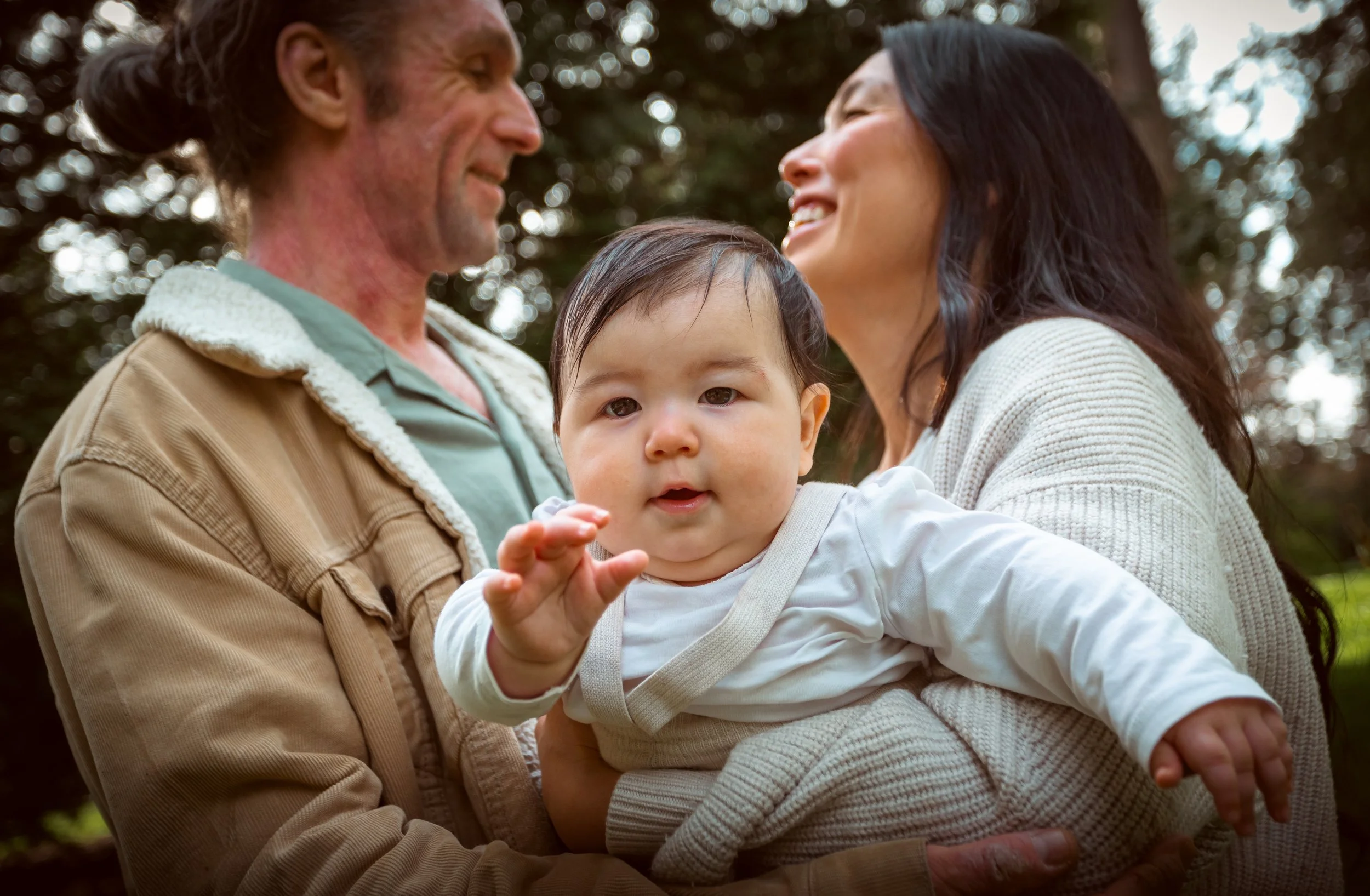 Vancouver Family Photographer shares a sweet moment between parents holding there baby.