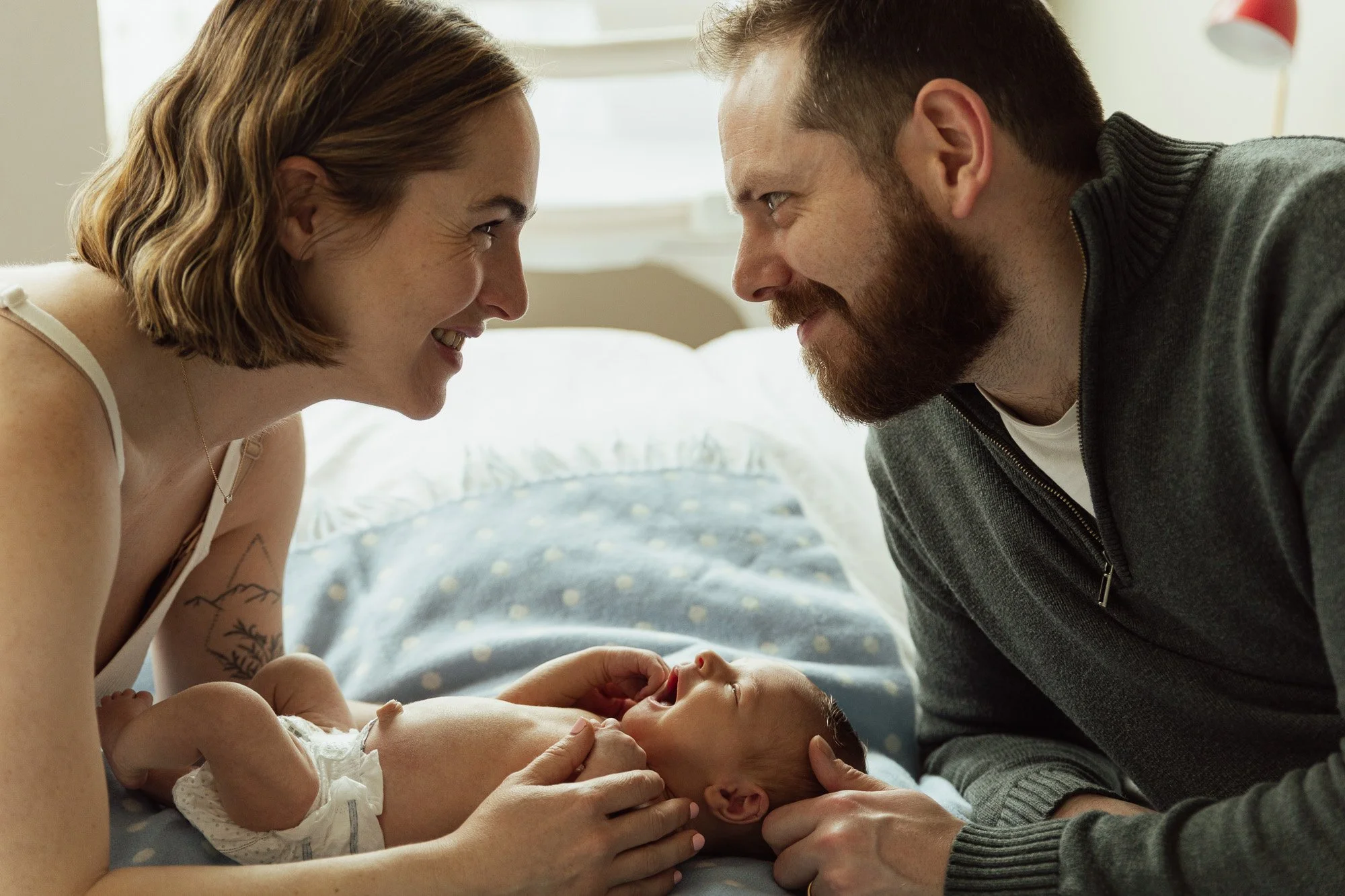 Newborn photographer capture a sweet moment of parents in love with their newborn