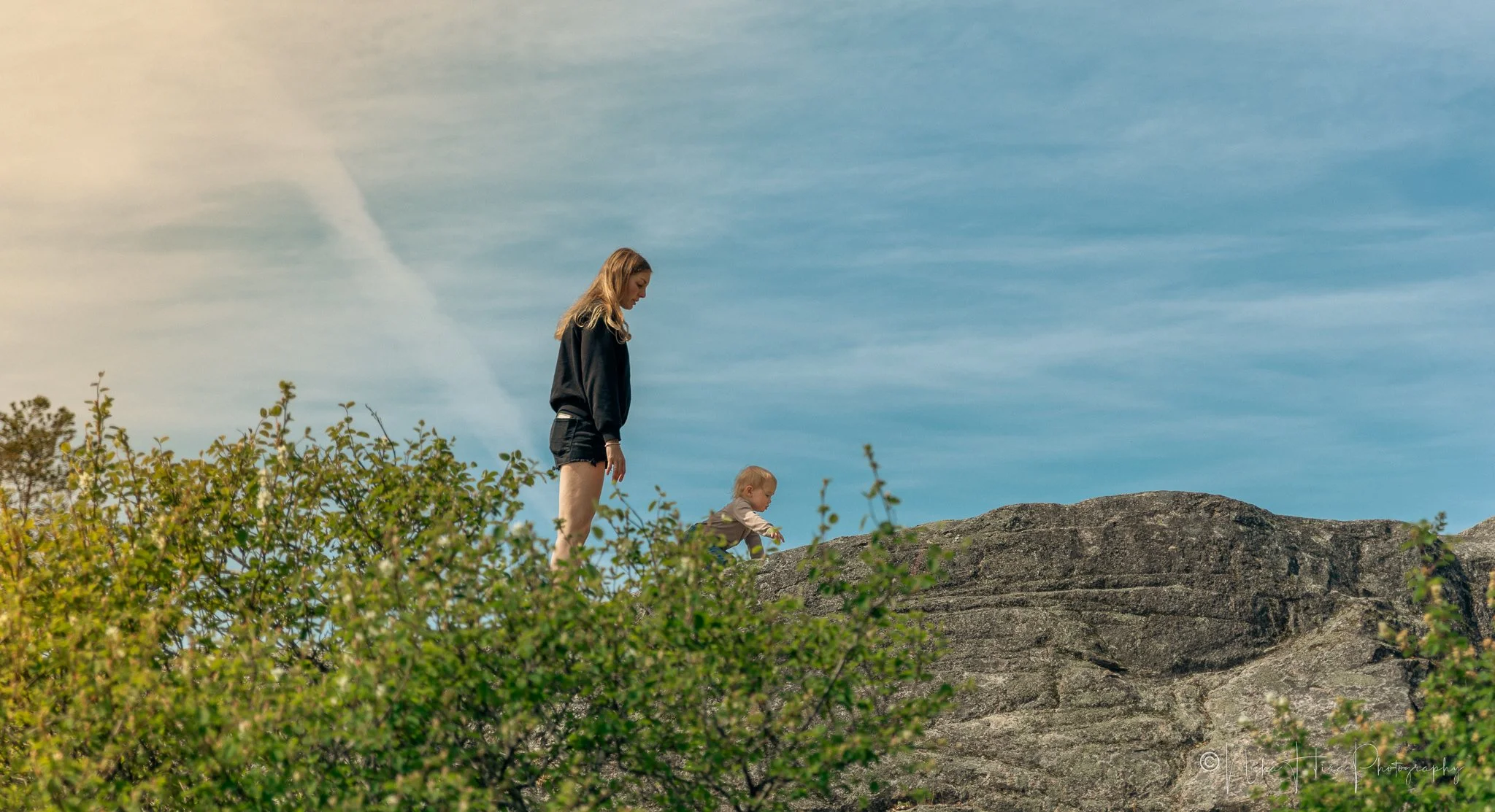 Mother and toddler walking together on rocky bluff at Lighthouse Park, West Vancouver, candid family photography