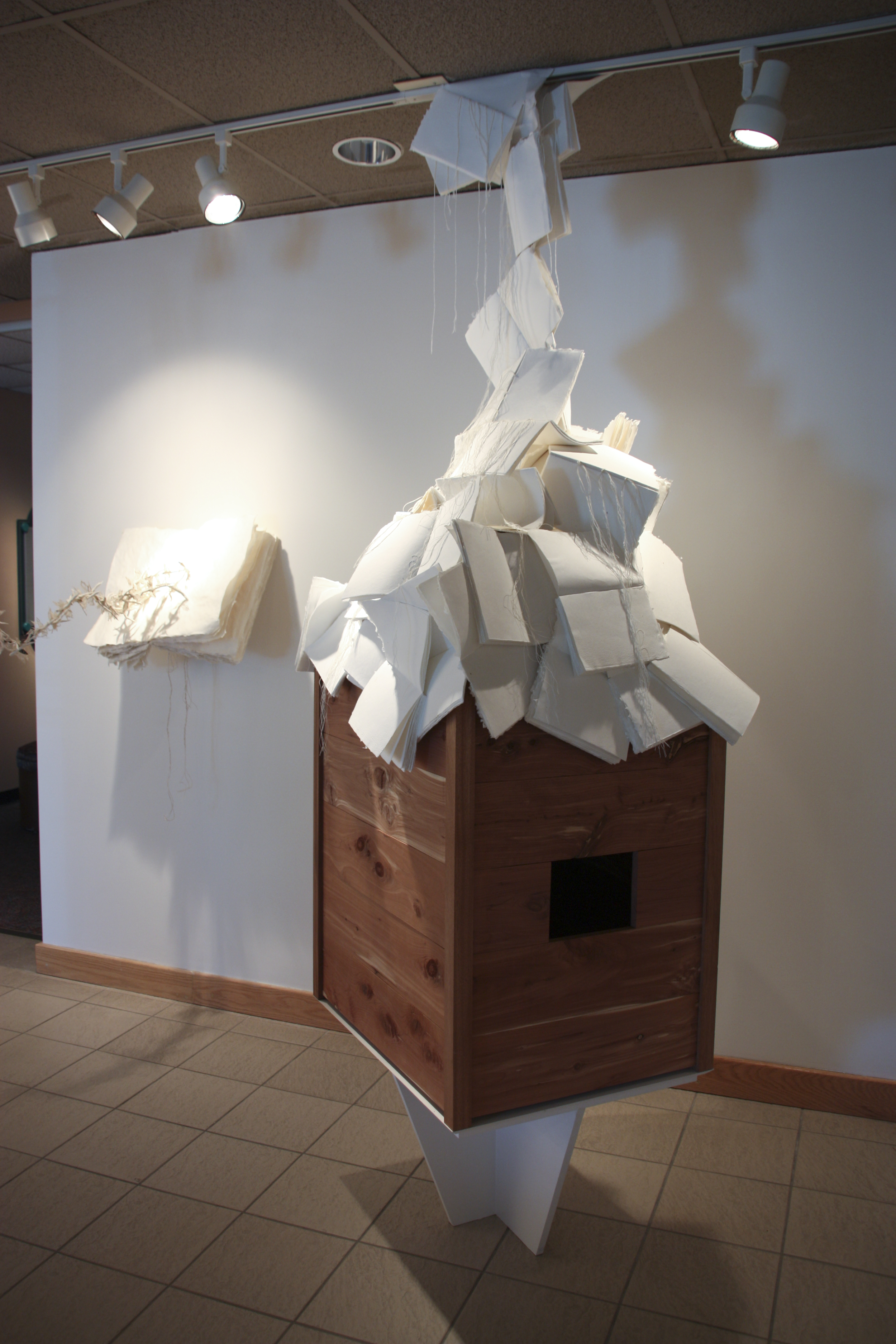    I’m silent  , 2013 sculpture featuring interior sound installation; installation view  handmade paper and books (abaca, bamboo, hemp), cedar, mahogany, linen thread, sound  Irving Arts Center 