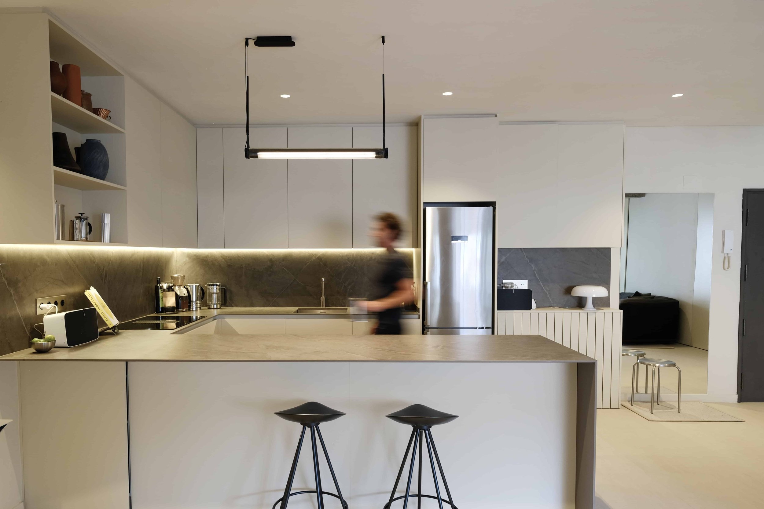 Casa Costa Barcelona healthy interiors retrofit living room with durable ceramic flooring and layered lighting