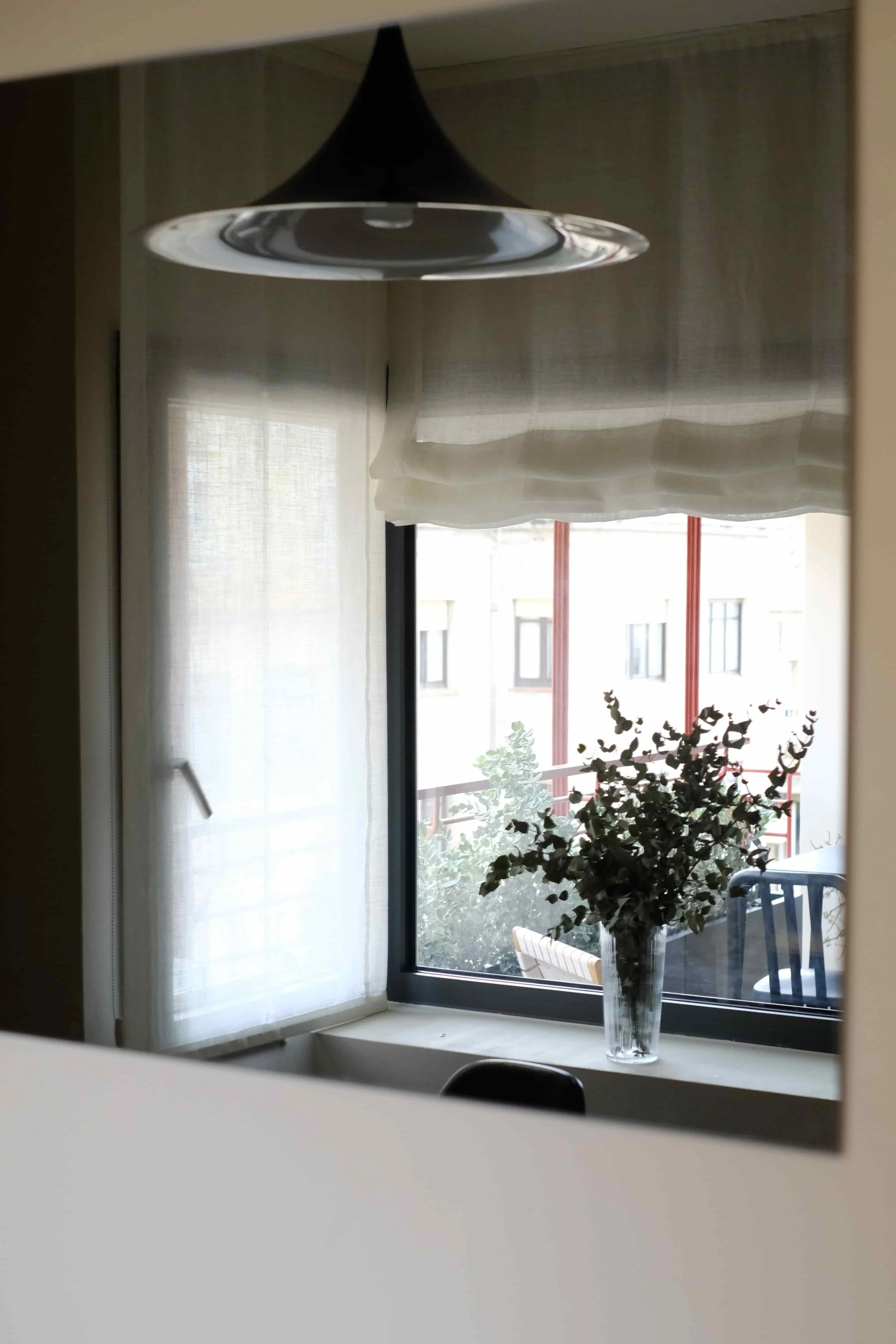 casa costa barcelona window view with linen curtains, live edge oak table and outdoor furniture