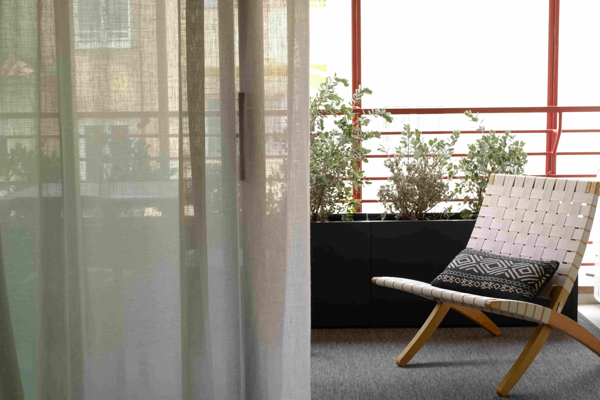 casa costa barcelona terrace, linen curtains, cotlin rug, hans wagner folding chair