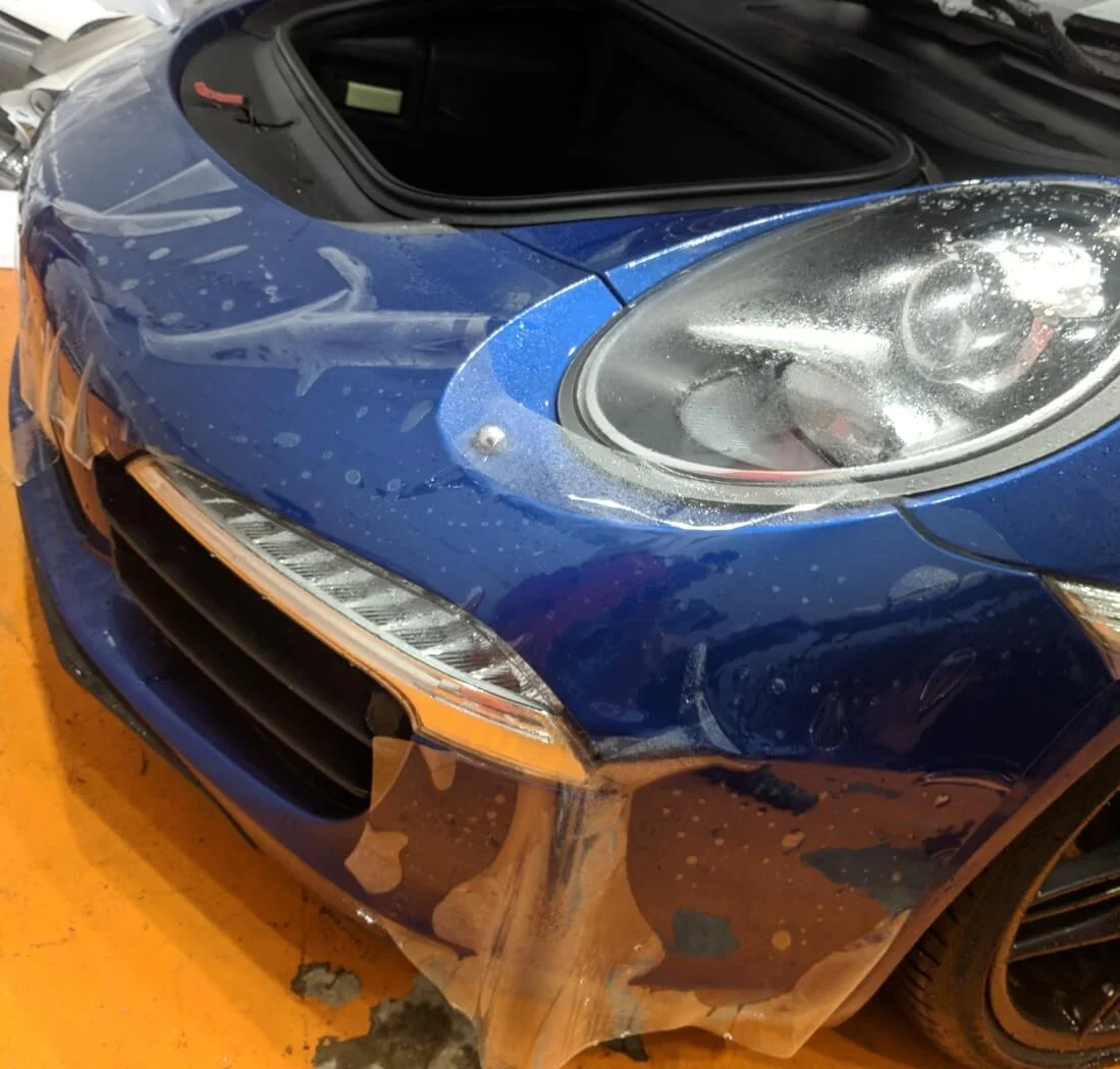 Porsche 911 getting pre-cut Xpel Ultimate paint protection film on front bumper
