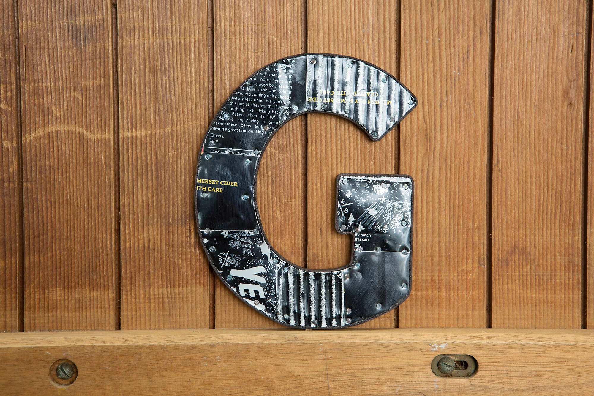 letter G tin soda cans recycling