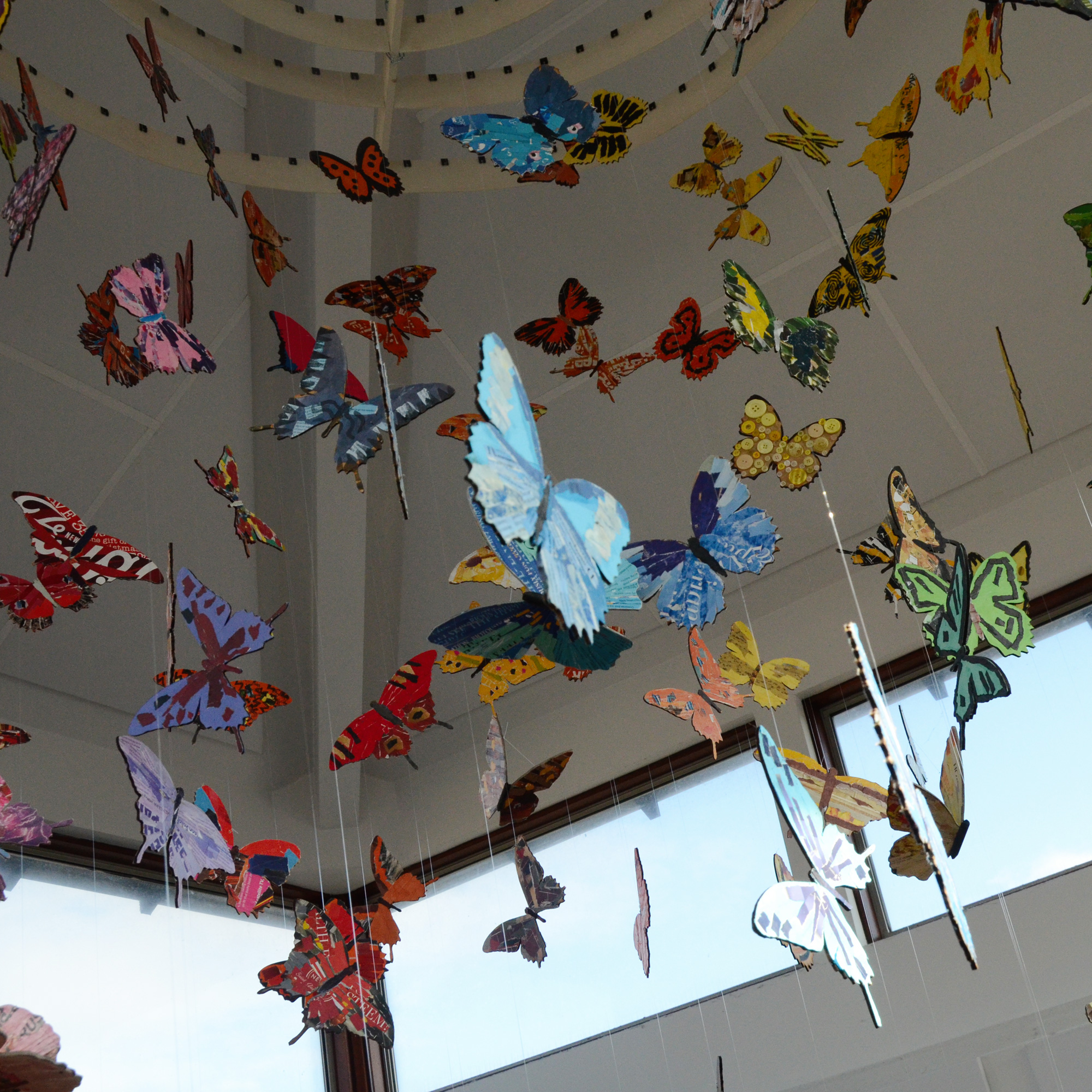 collaged butterflies hanging from ceiling