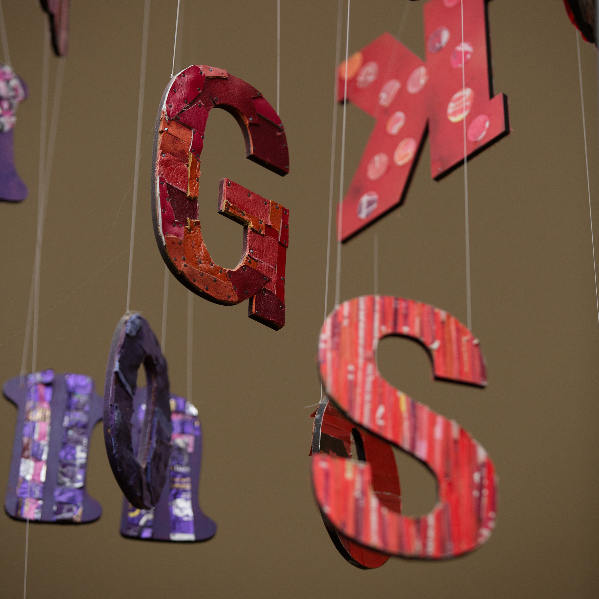 colourful letters dangle from art project
