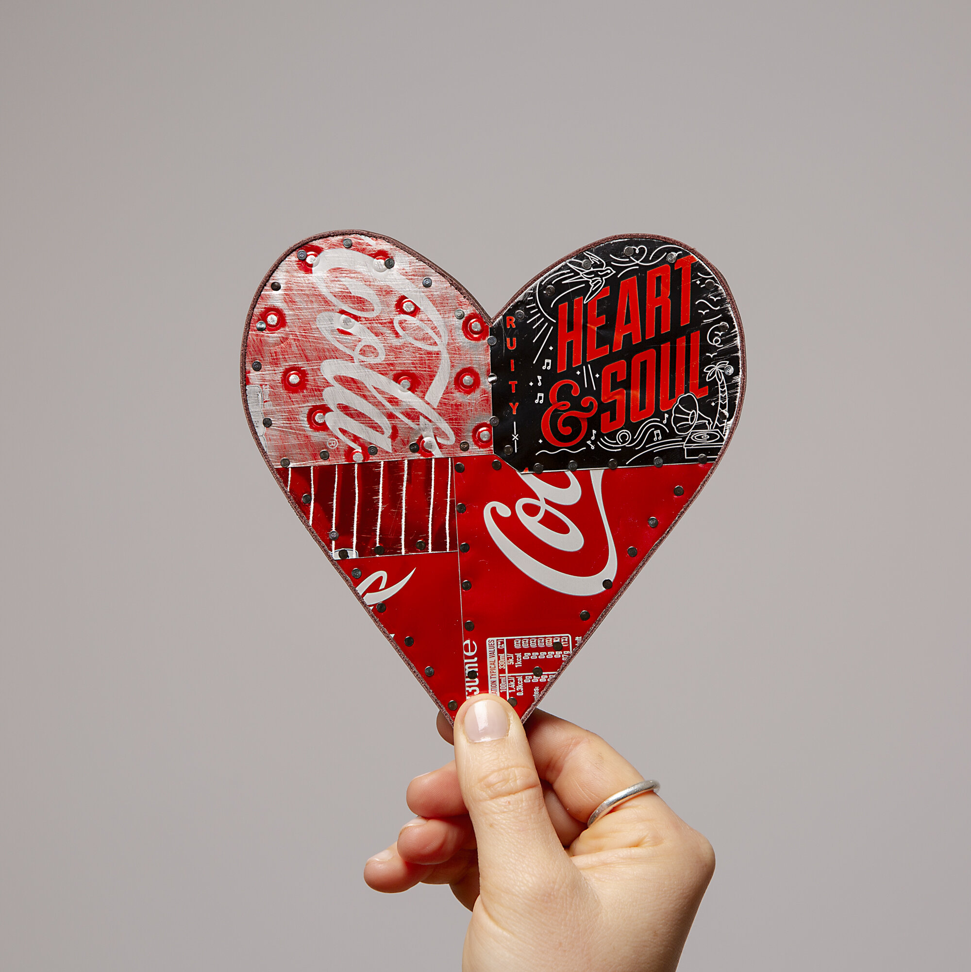 Red drinkscan soda can handmade heratshape with Coca Cola tin held by hand