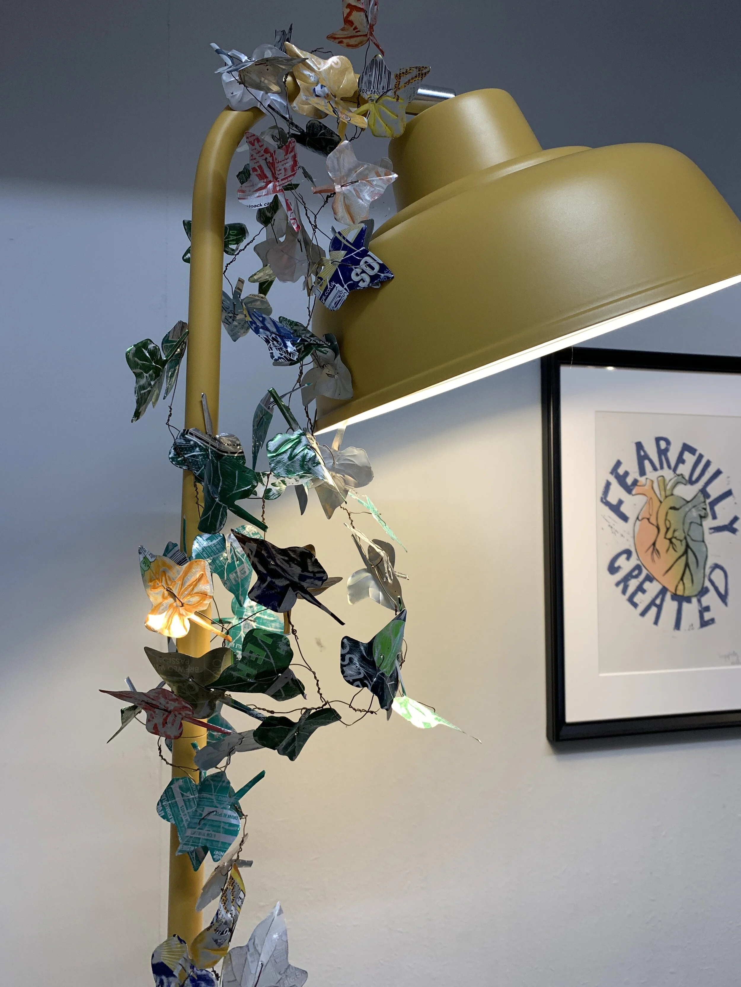 Metal ivy leaf garland decorating yellow metal lamp in art studio