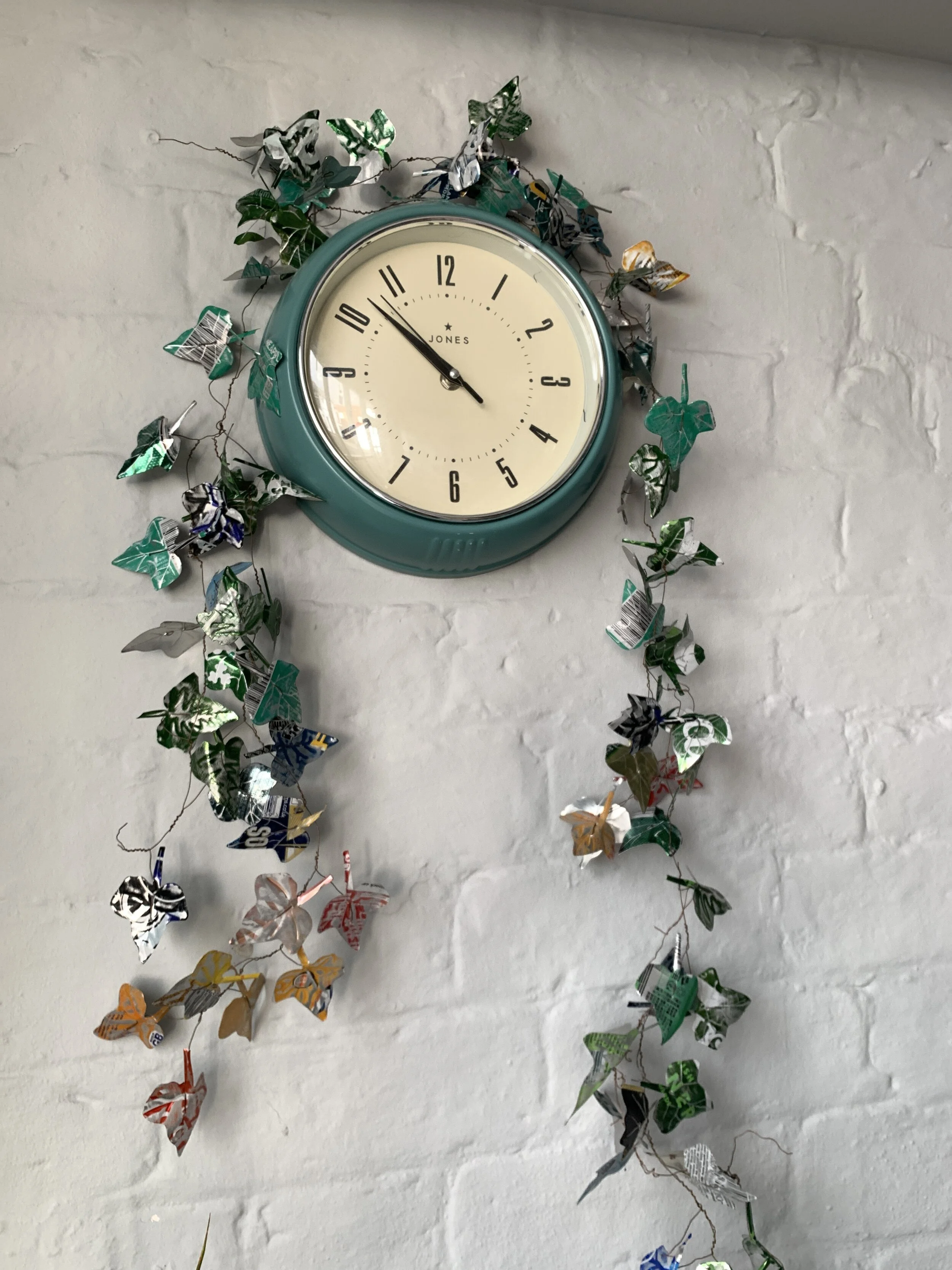 ivy drape in green beer an metal festoon decorative on clock on wall