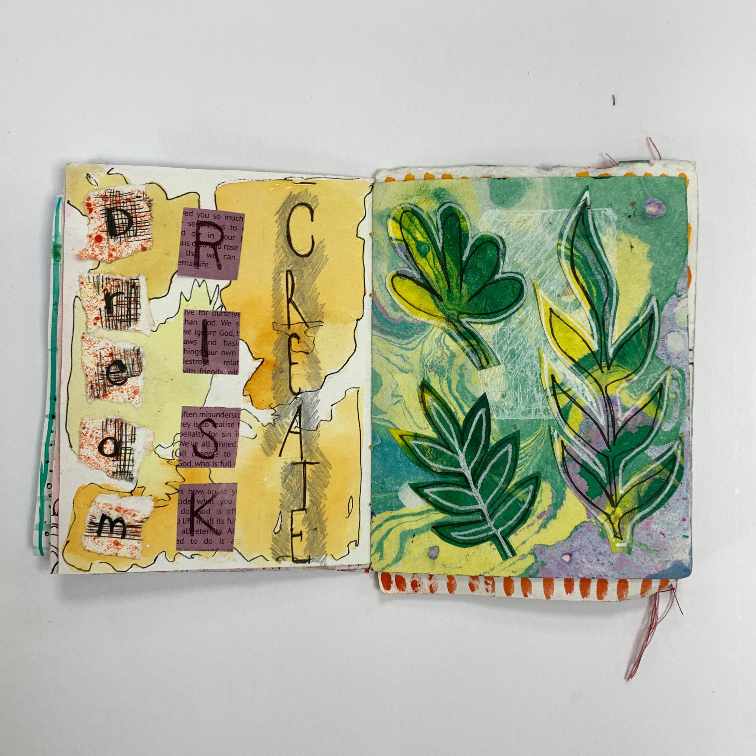 Artjournal open with two collage pages plant leaves decorative artwork hand drawn drawings green and yellow happy