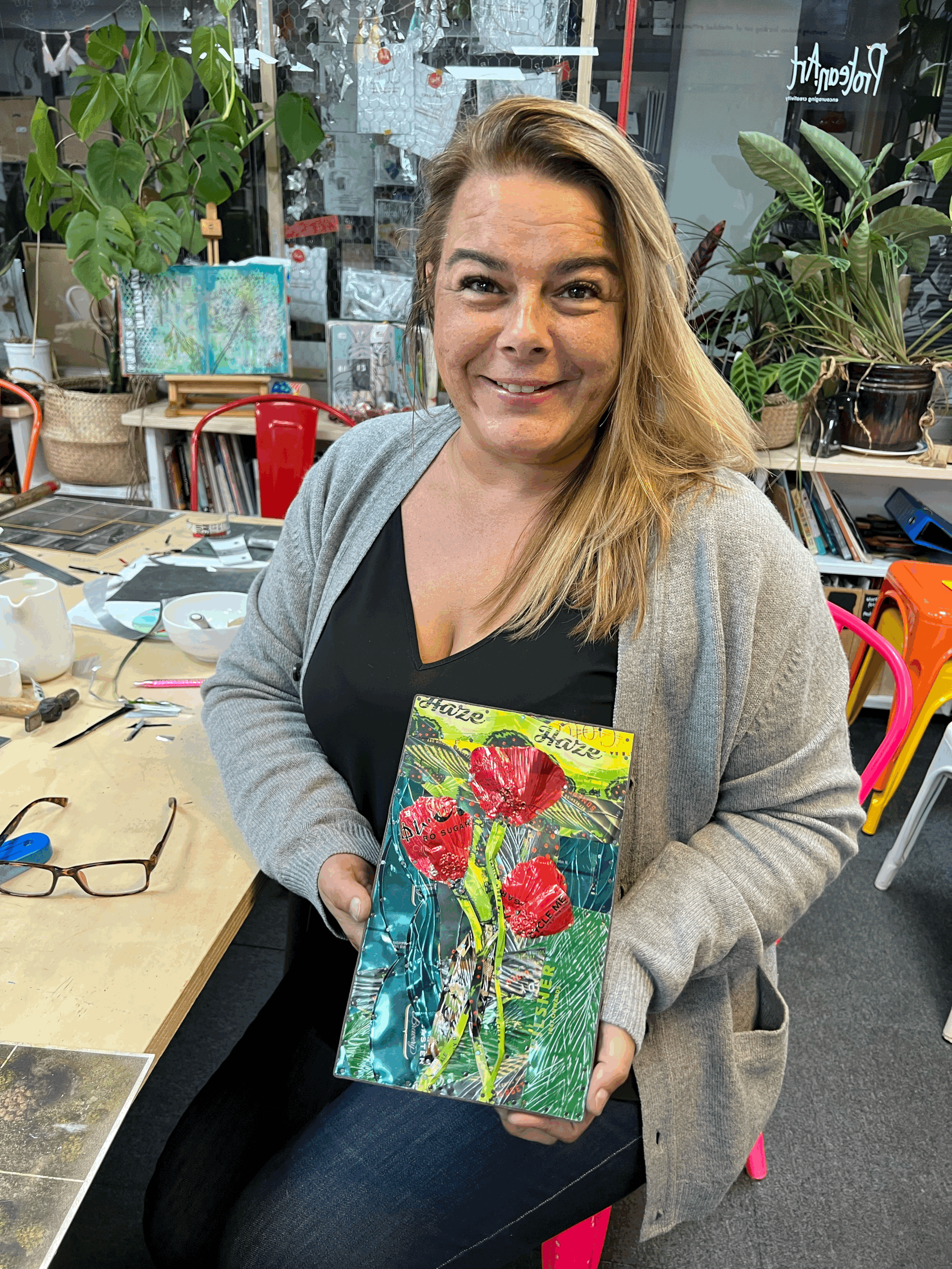 Smiling lady with long blond hair holding her drinks can art work of polls on a drinks can background d in a studio workshop in Stafford with Proteanart