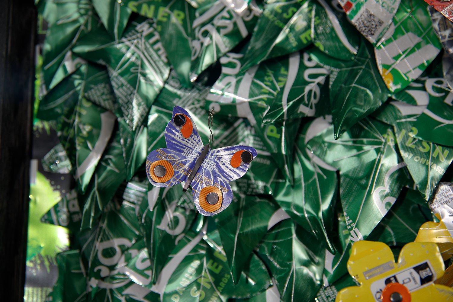 blue butterfly on green metal leaves.jpg