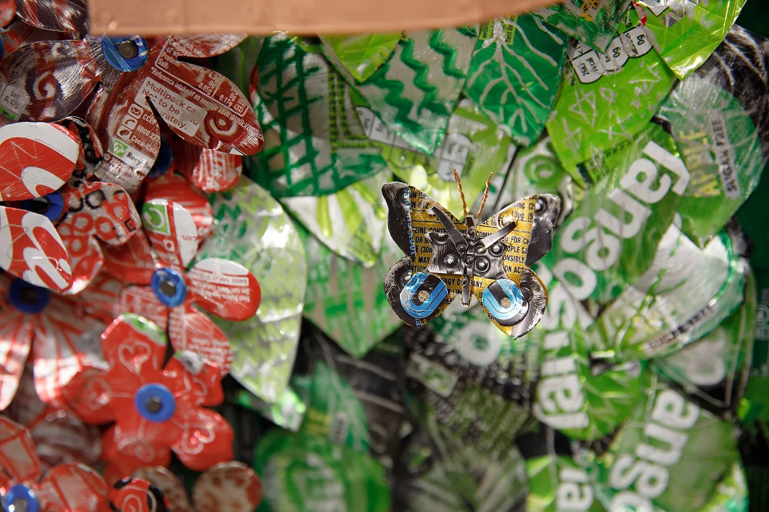yelloe black and blue butterfly on green metal leaves.jpg.jpg